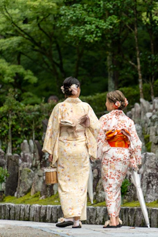 A couple of women walking down a street