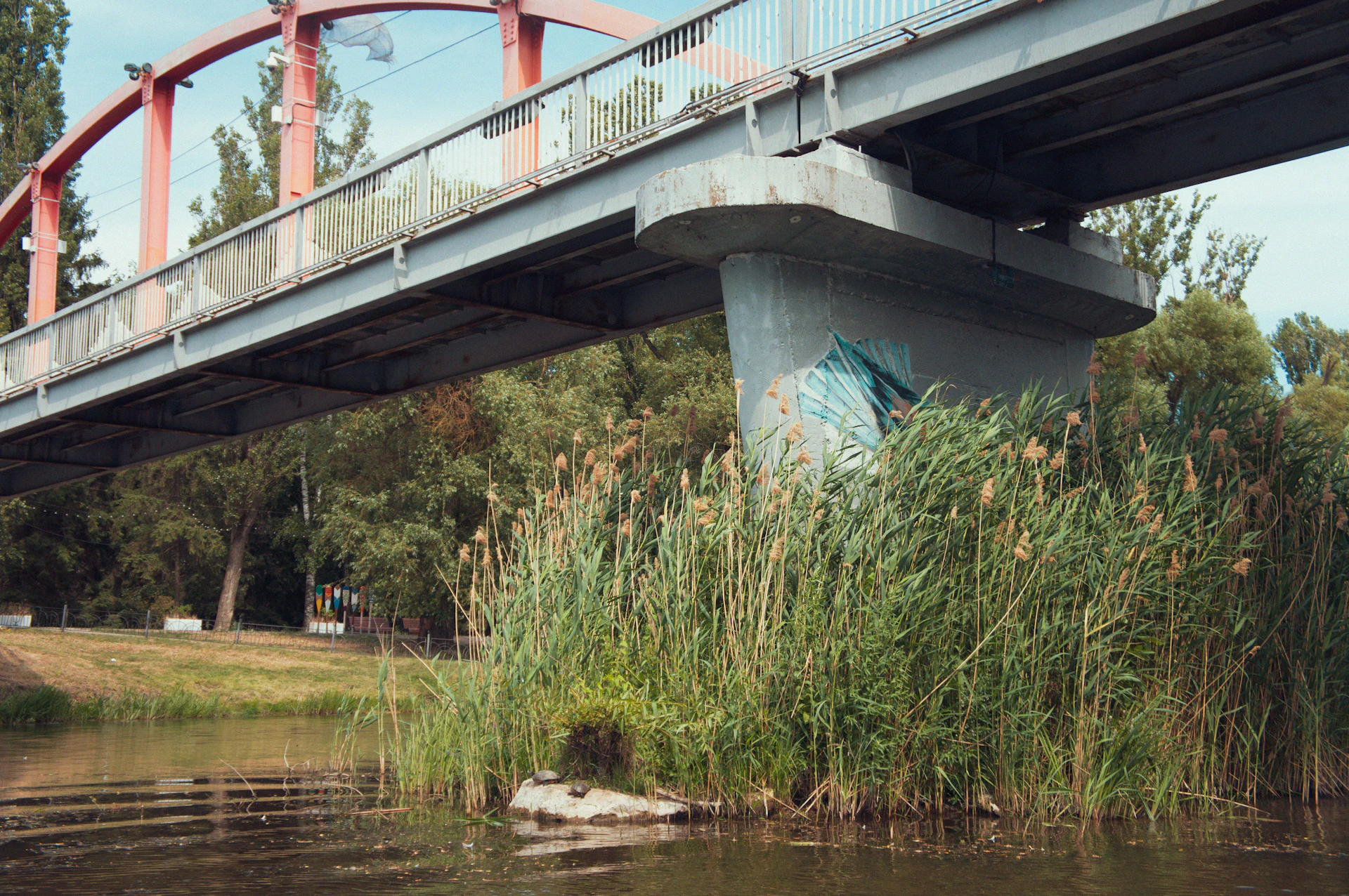 A red bridge over a body of water