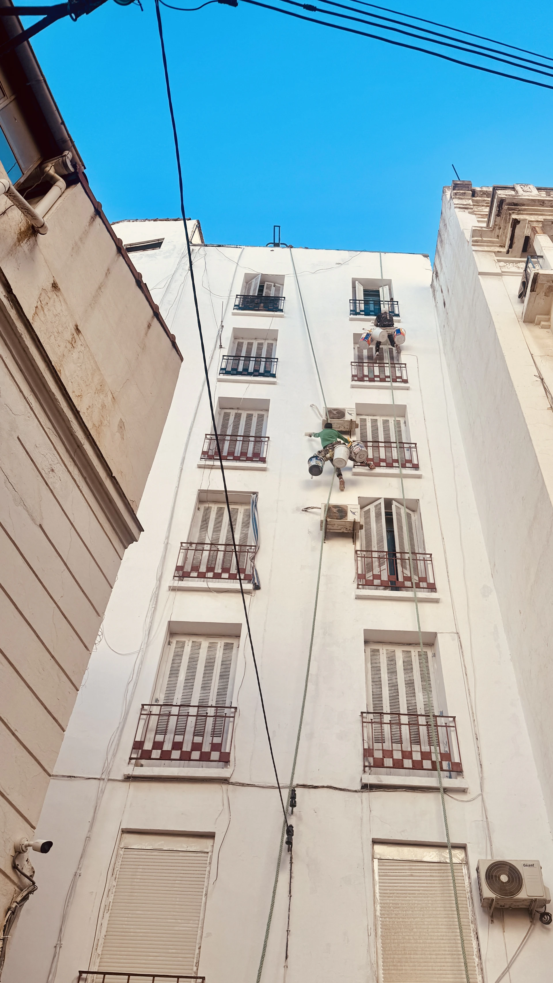 A tall white building with lots of windows