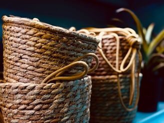 Three woven baskets sitting on top of a blue shelf