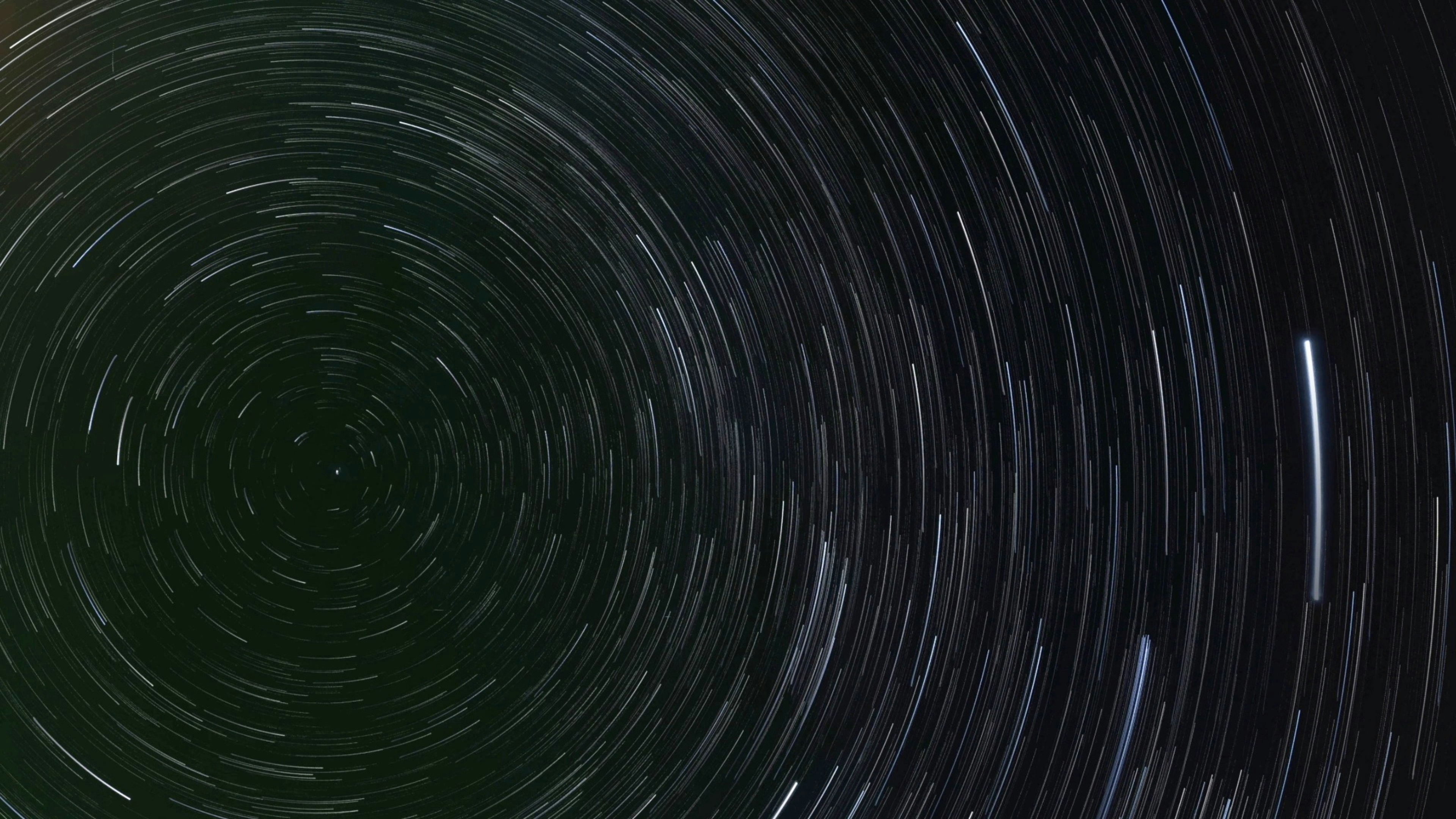 A black and white photo of a star trail