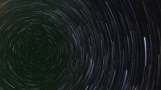 A black and white photo of a star trail