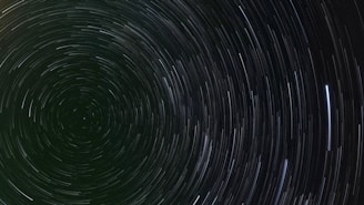 A black and white photo of a star trail