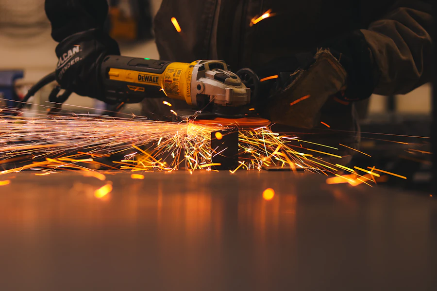 Worker using an angle grinder on metal