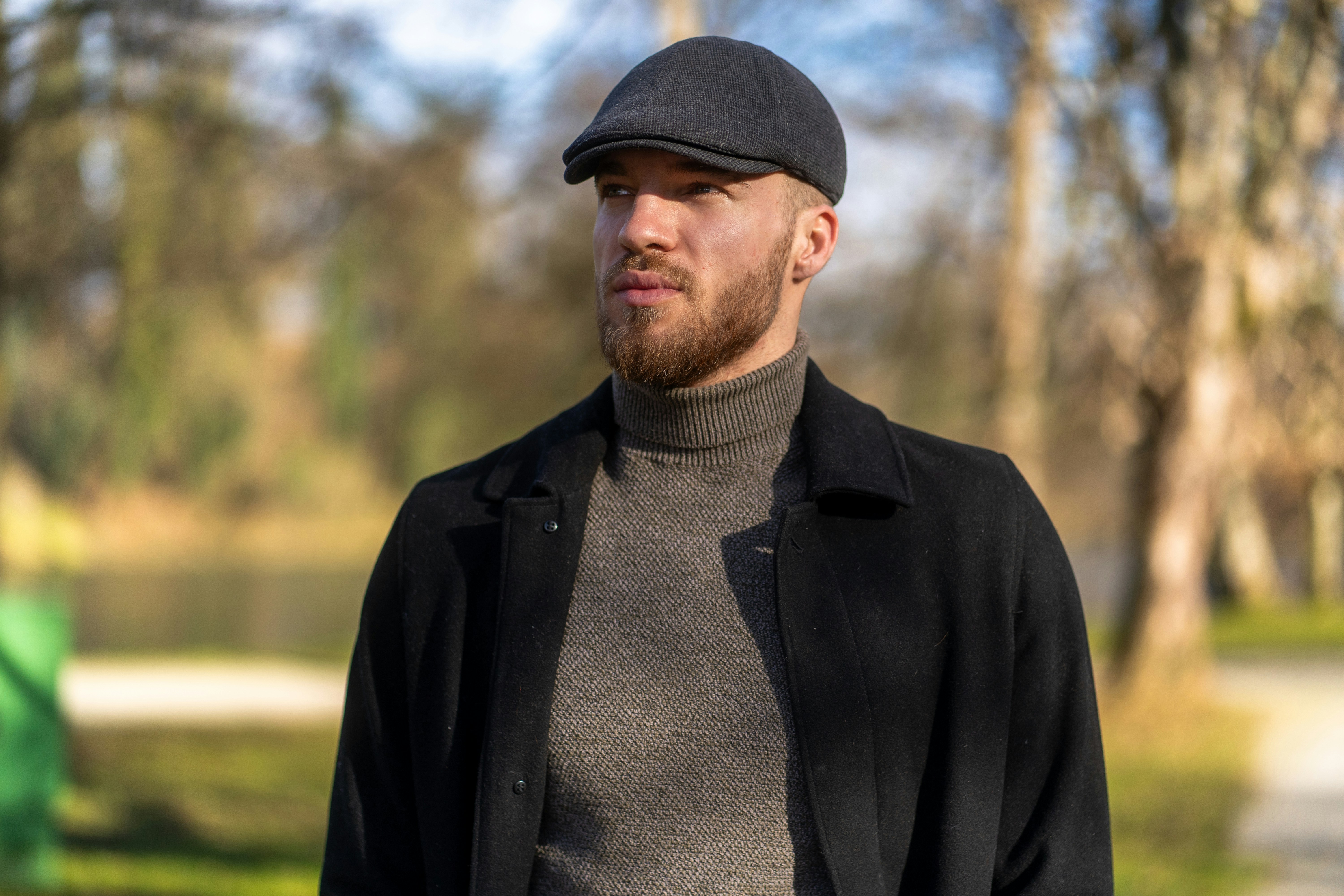 A man wearing a hat and a black jacket