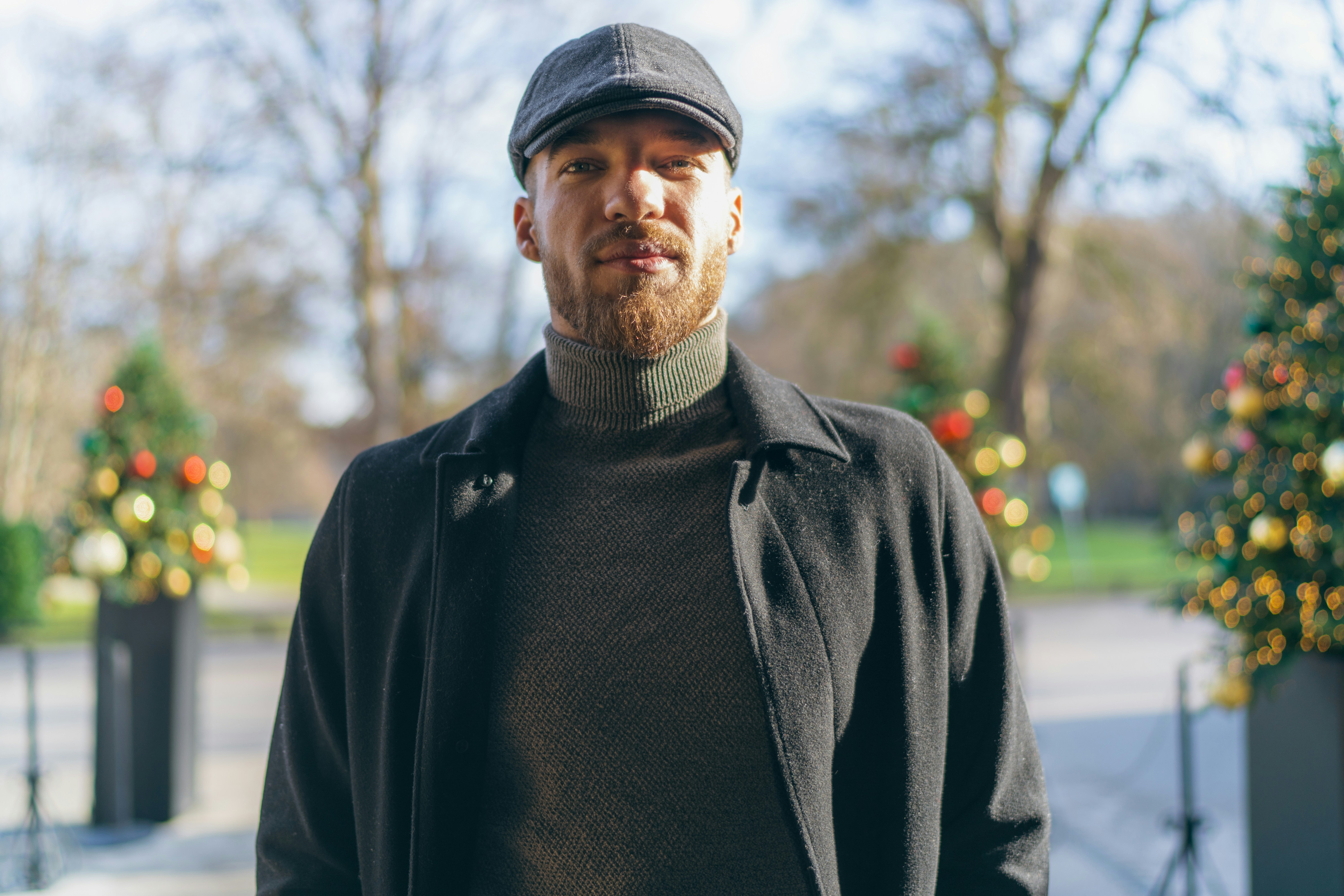 A man standing in front of a christmas tree