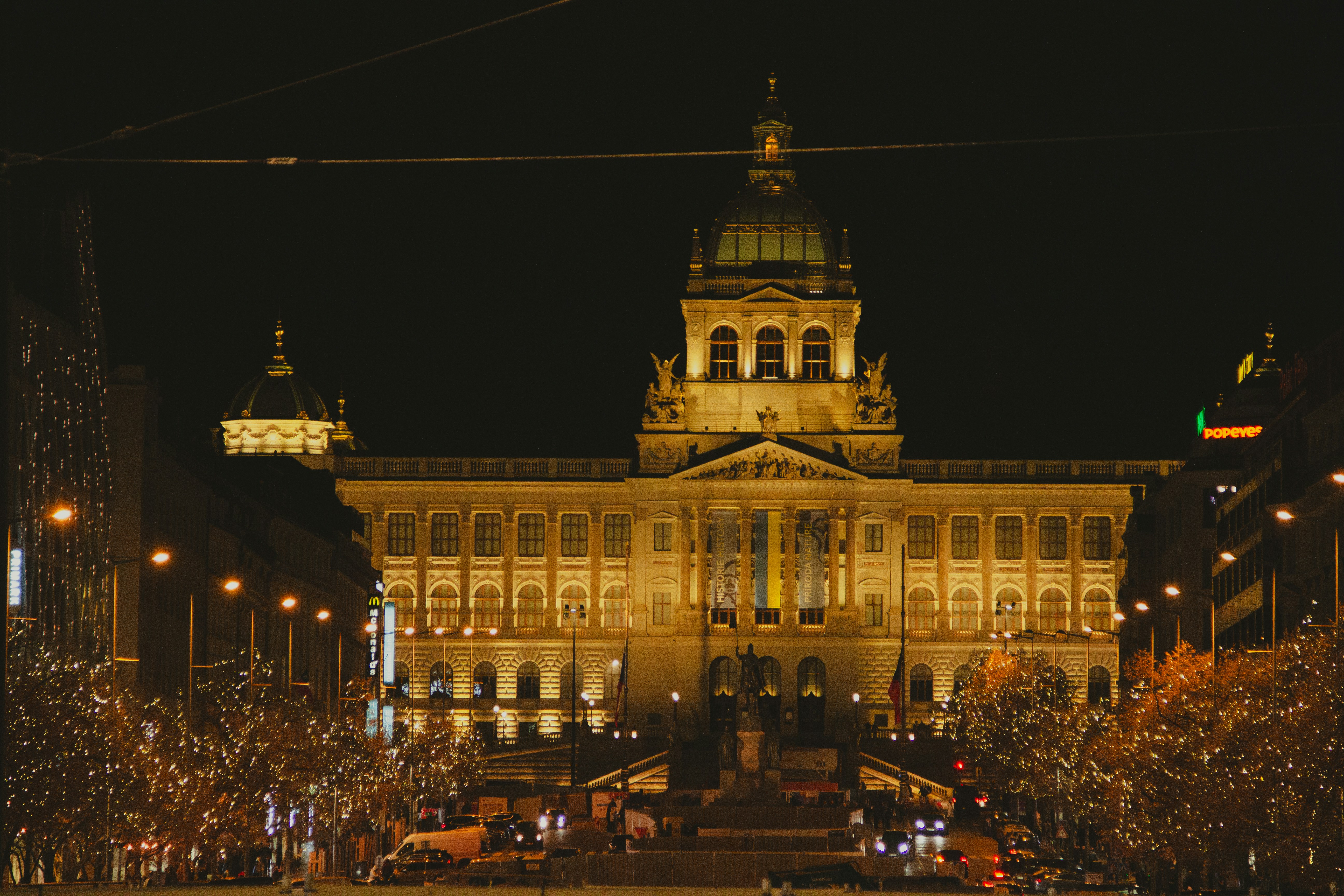 A large building with a clock tower at night