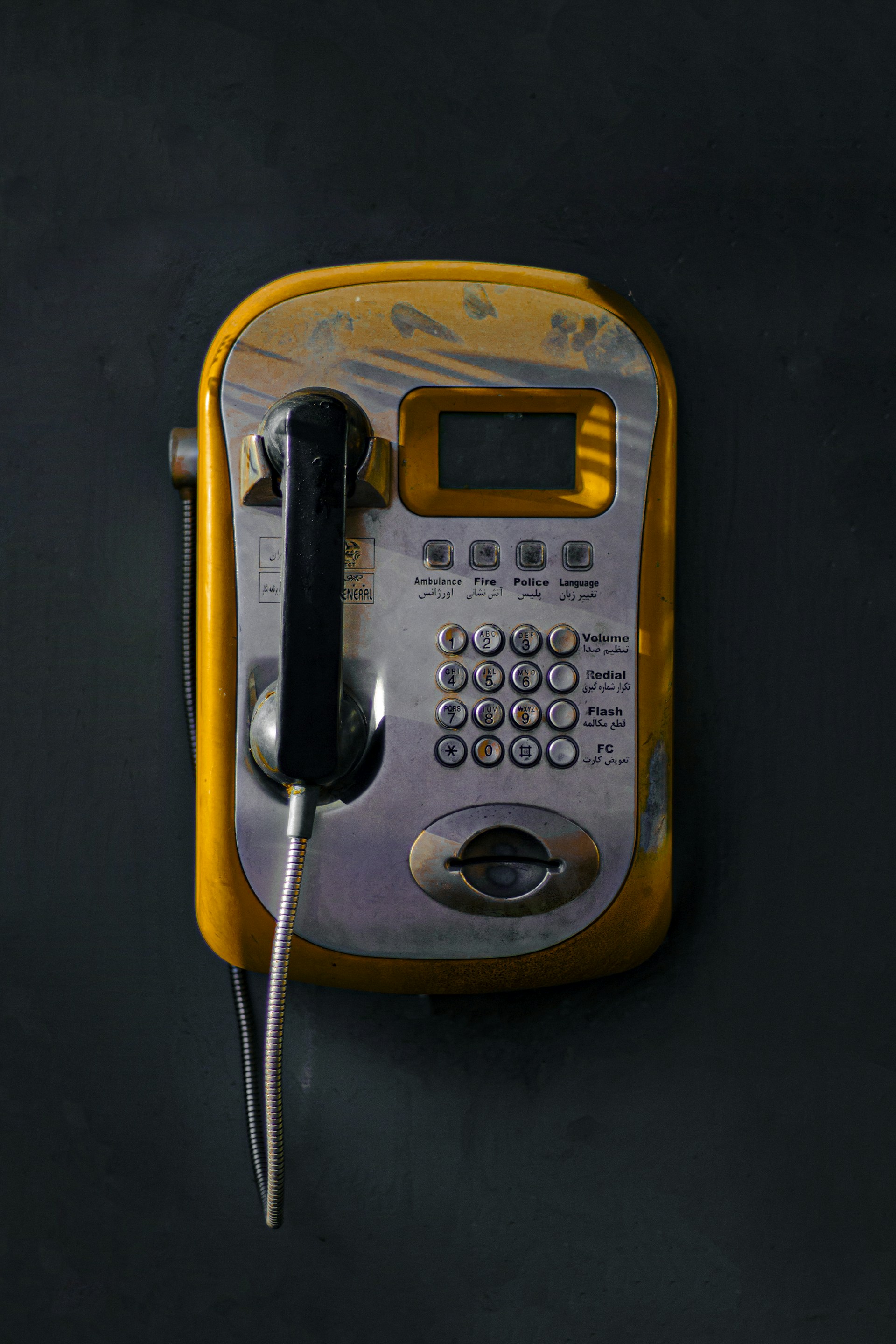 An old style telephone with a cord attached to it