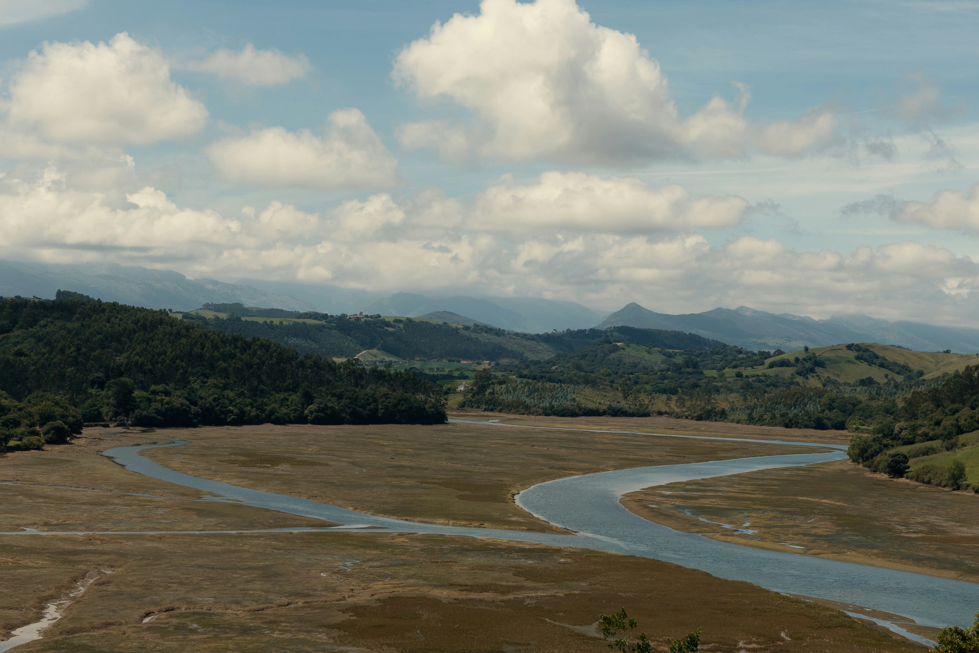 A river running through a lush green countryside