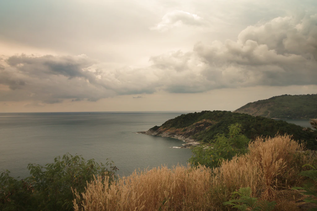 Moody sky over a green headland and the sea