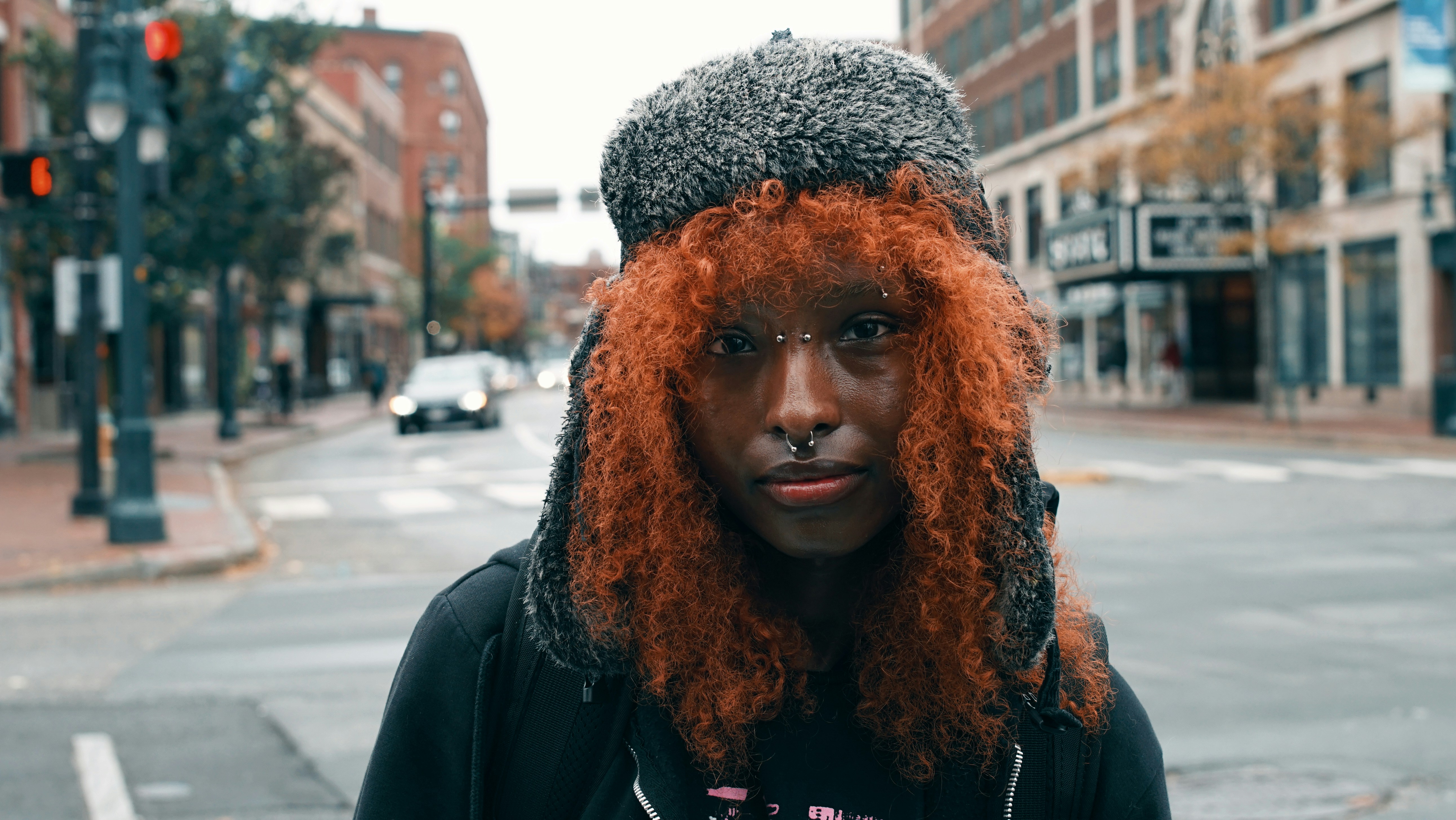 A man with red hair wearing a hat