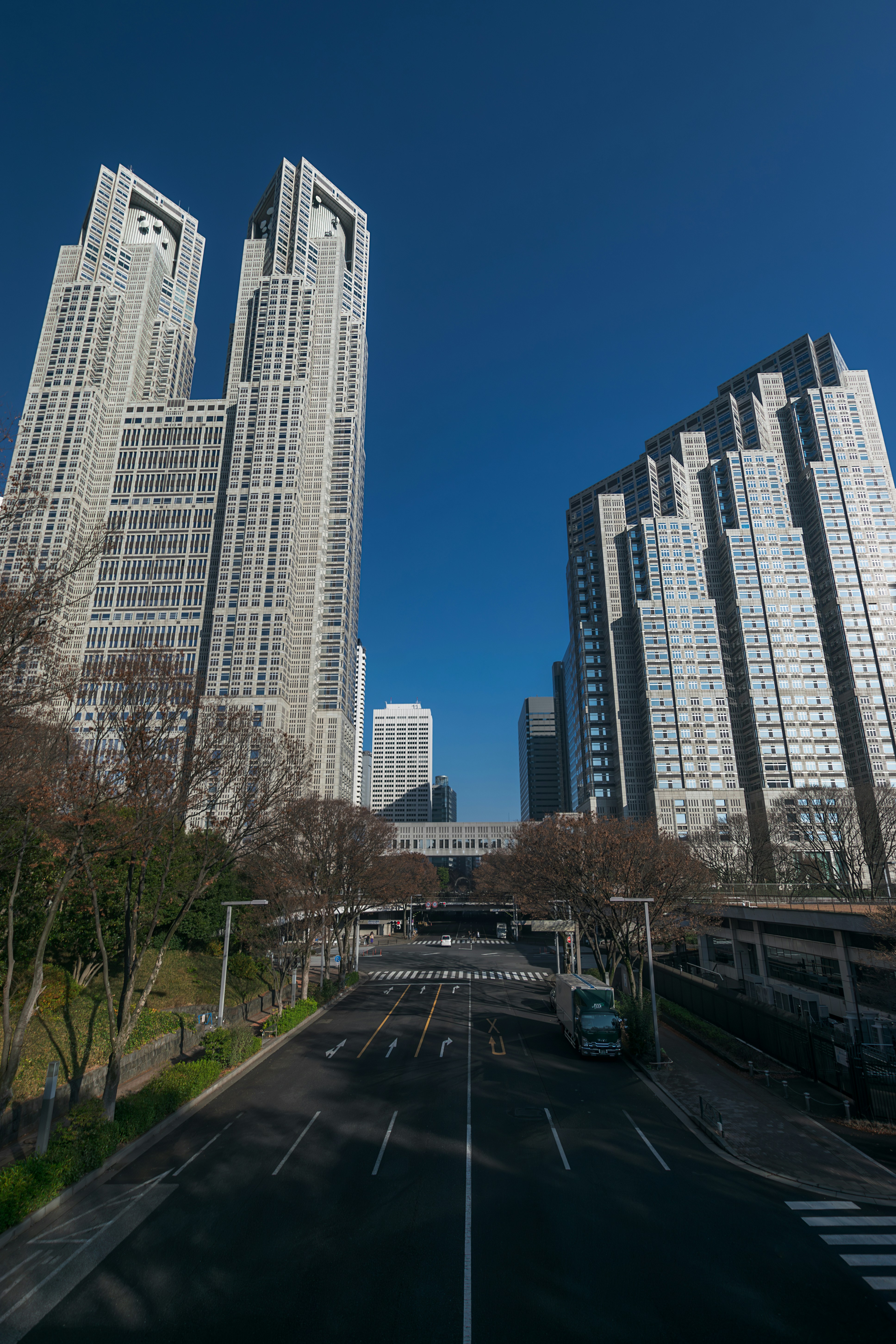 A city street with tall buildings in the background