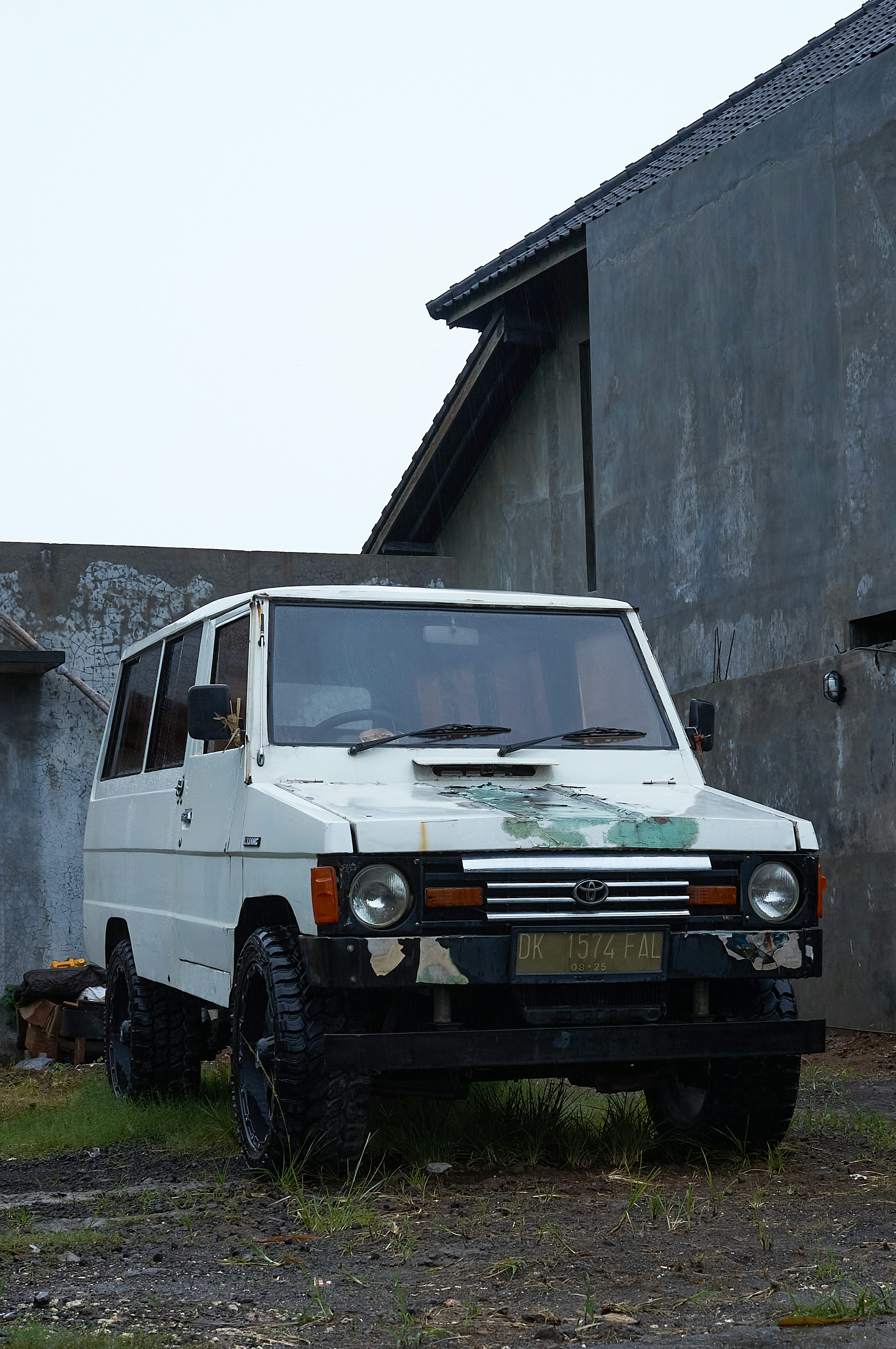 A white van parked in front of a building