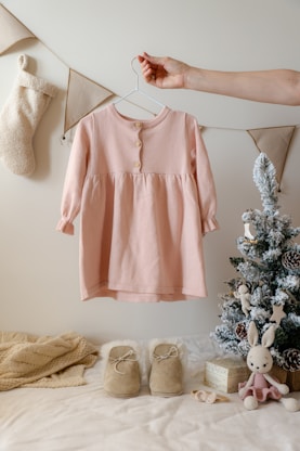 A baby's pink shirt hanging on a clothes line