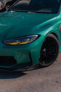 A green sports car parked in a parking lot
