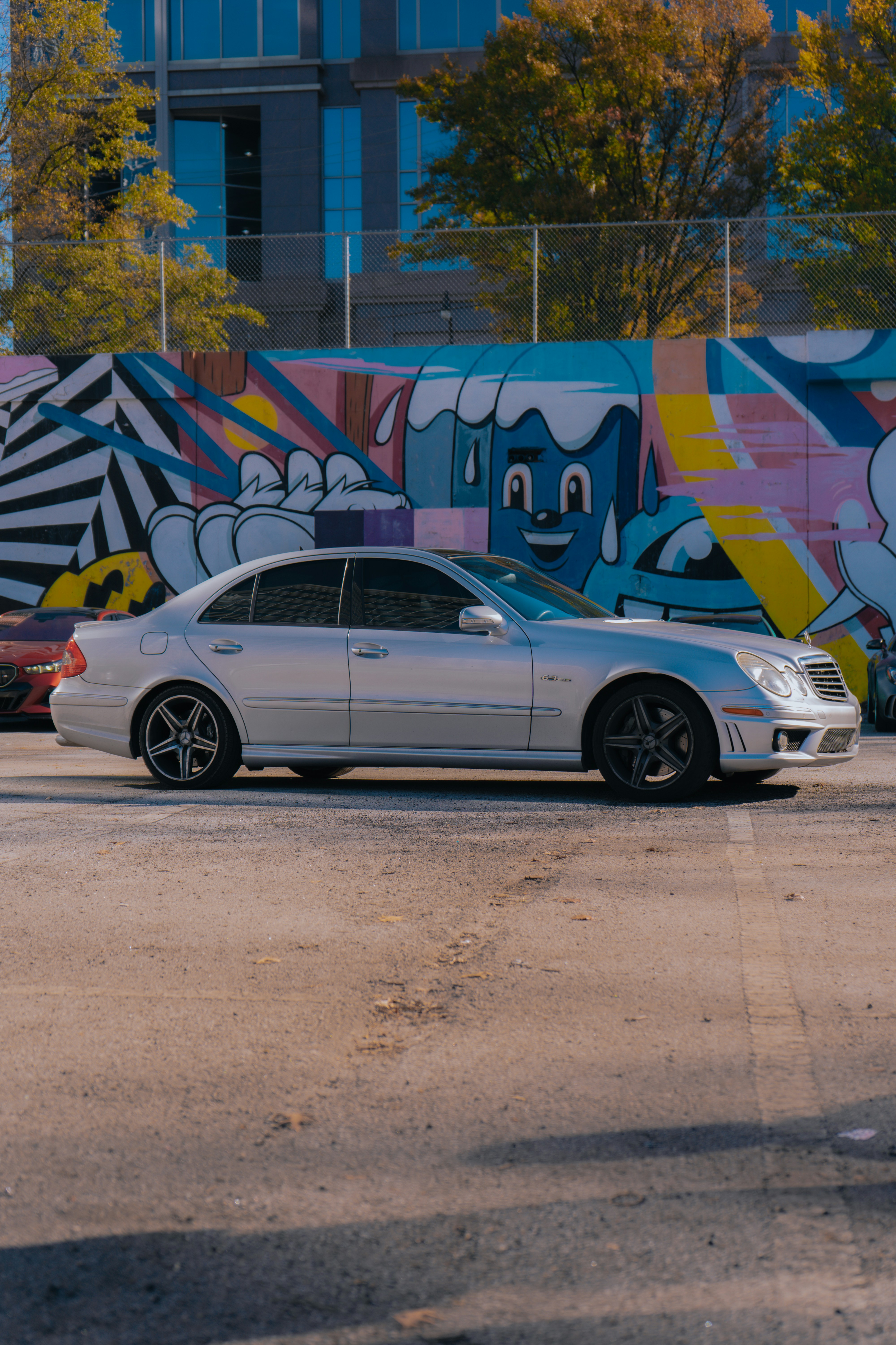 A white car parked in front of a colorful wall photo – Free Car Image ...