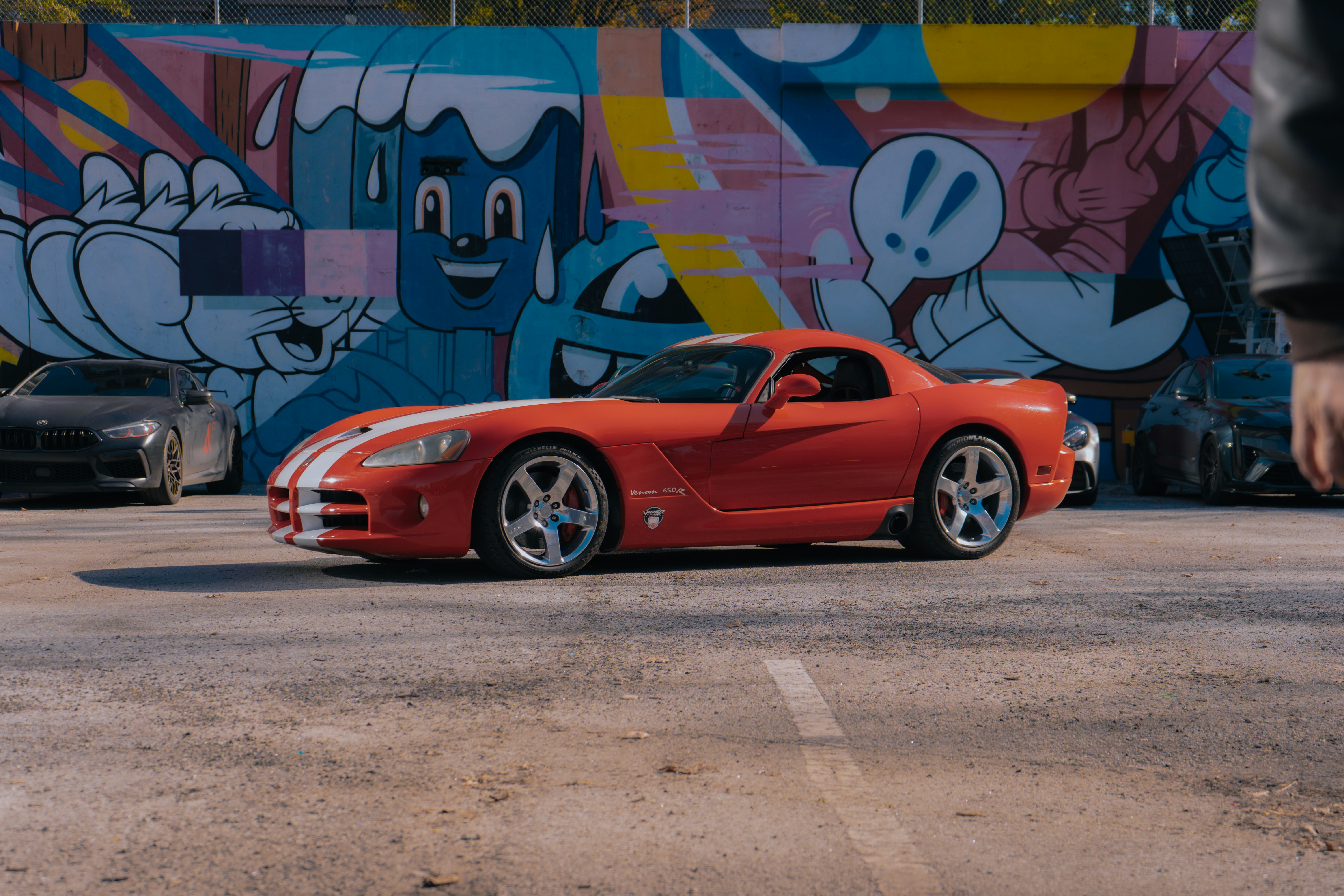 A red sports car parked in a parking lot