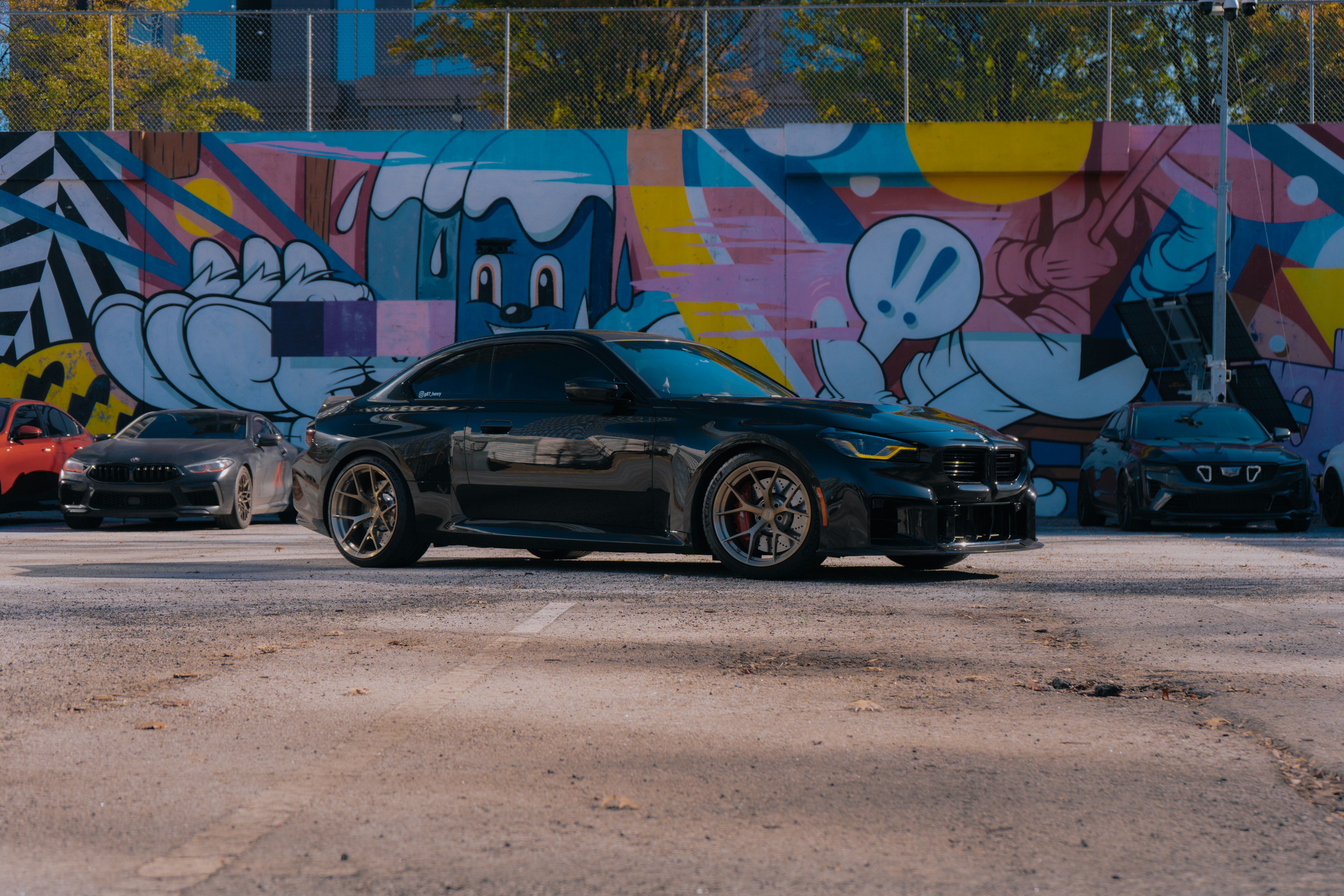 A couple of cars parked in front of a building