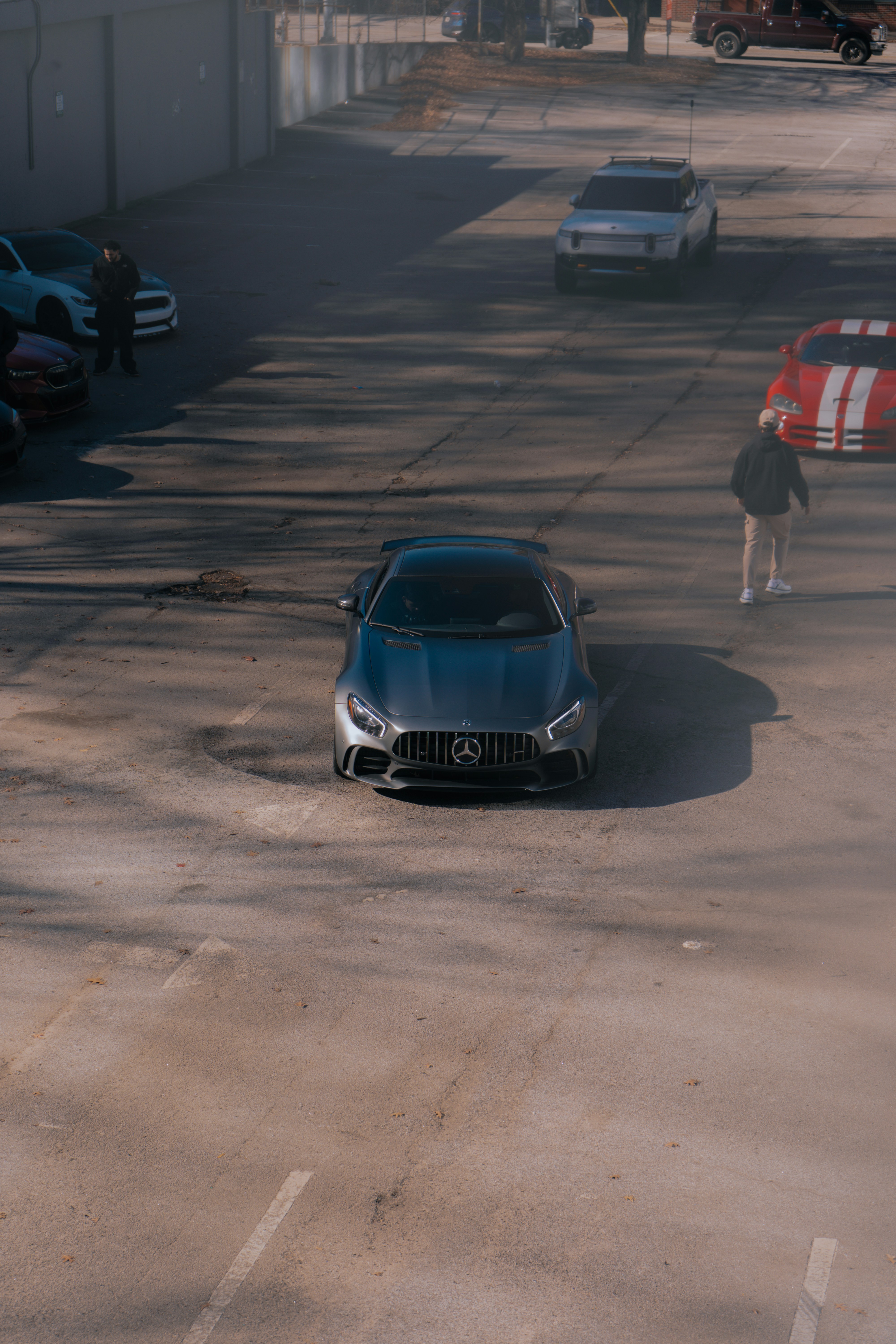 A car parked in a parking lot next to a building