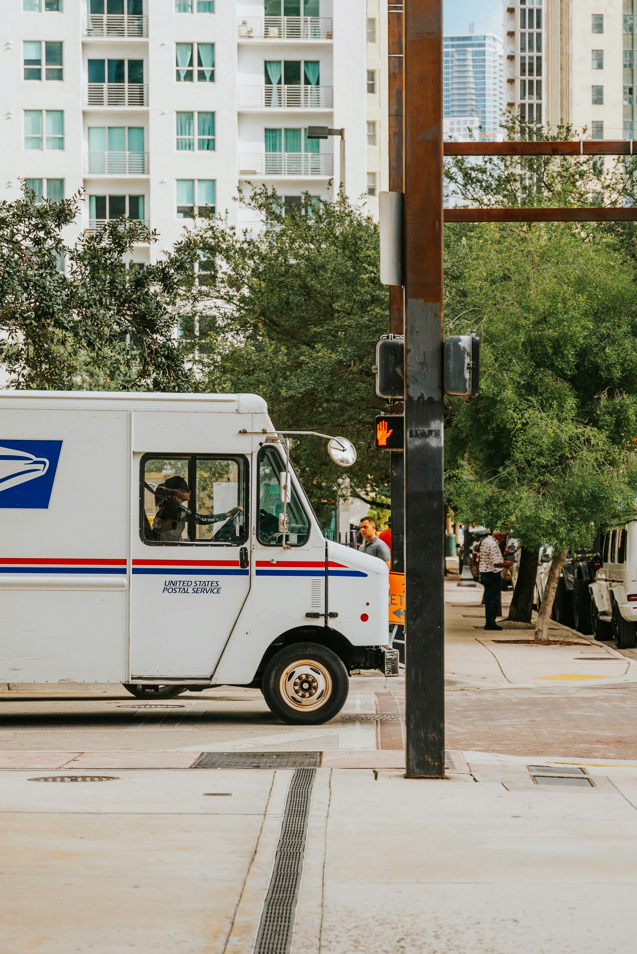 A mail truck parked on the side of the road photo – Free Miami Image on ...