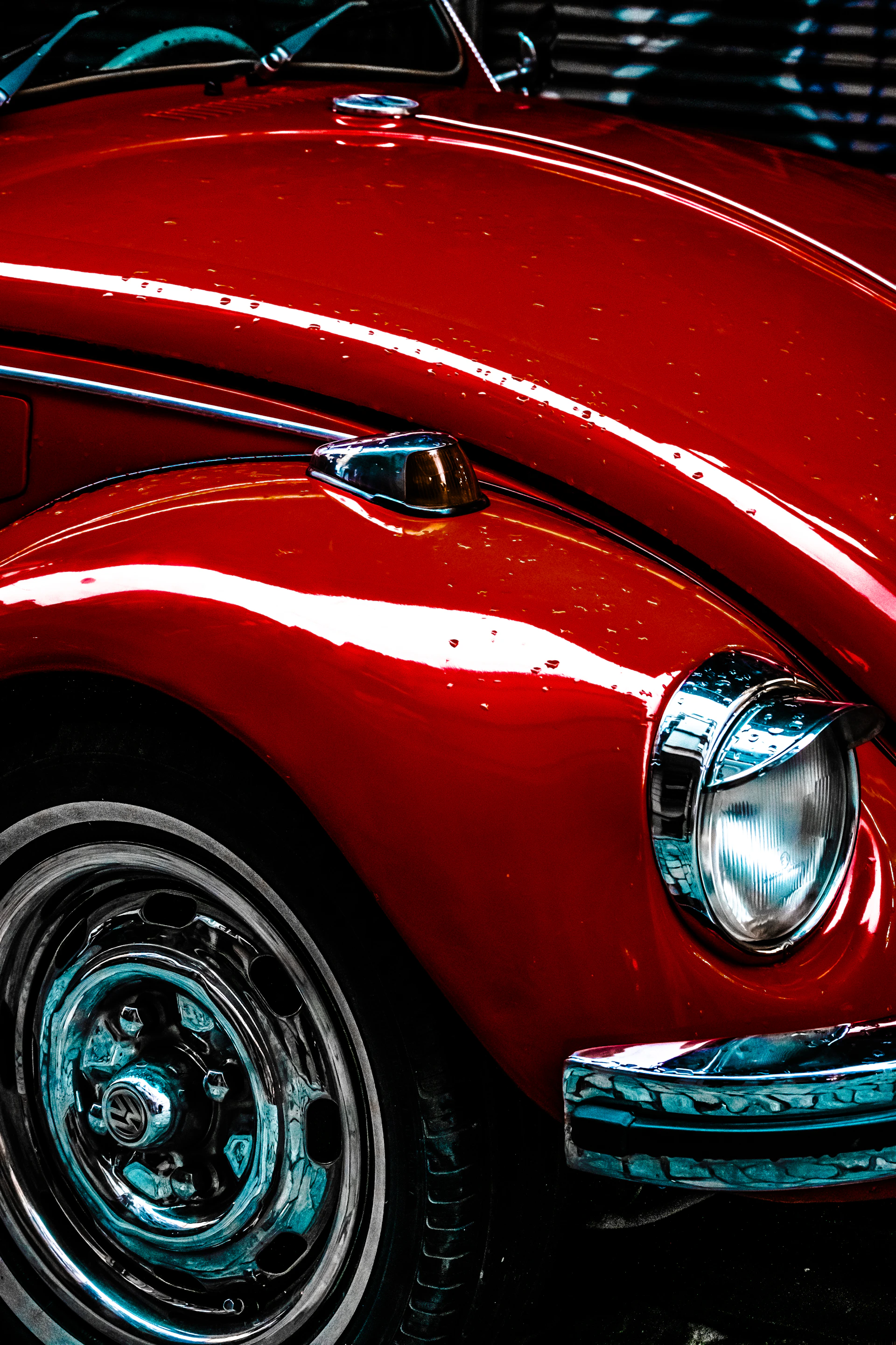 A close up of a red car parked in a parking lot