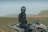 A man sitting on a motorcycle in a field