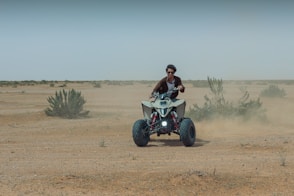 A man riding an atv in the desert