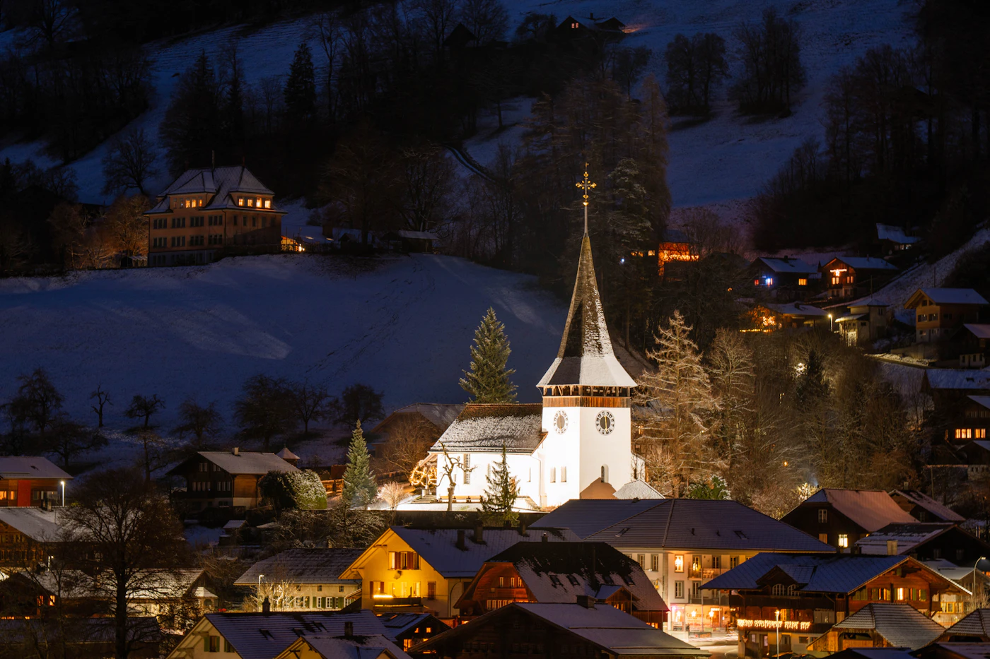 Snow-covered Alpine village lit at dusk on Christmas week, the inventory that sells twelve to eighteen months out