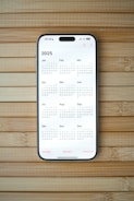 A white calendar on a wooden surface