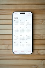 A white calendar on a wooden surface