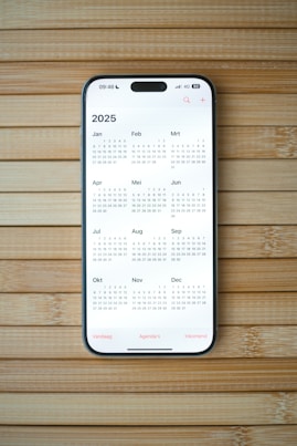 A white calendar on a wooden surface