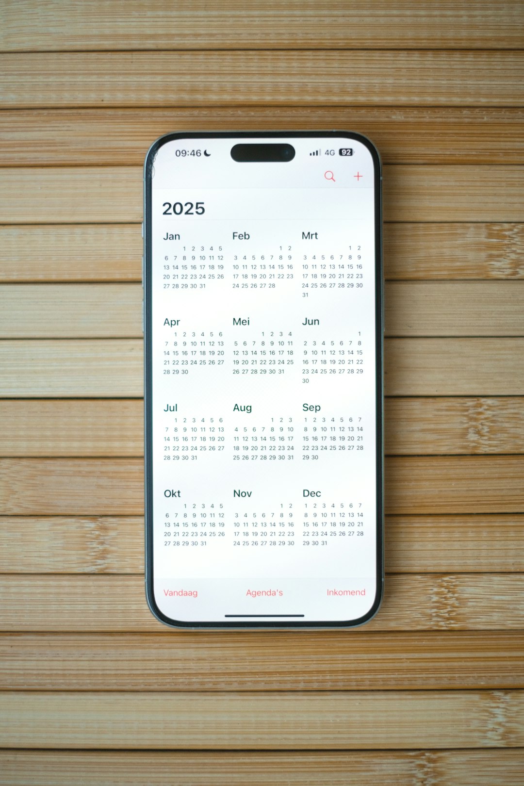A white calendar on a wooden surface