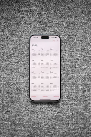 A white and black phone sitting on top of a gray surface