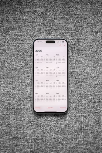 A white and black phone sitting on top of a gray surface