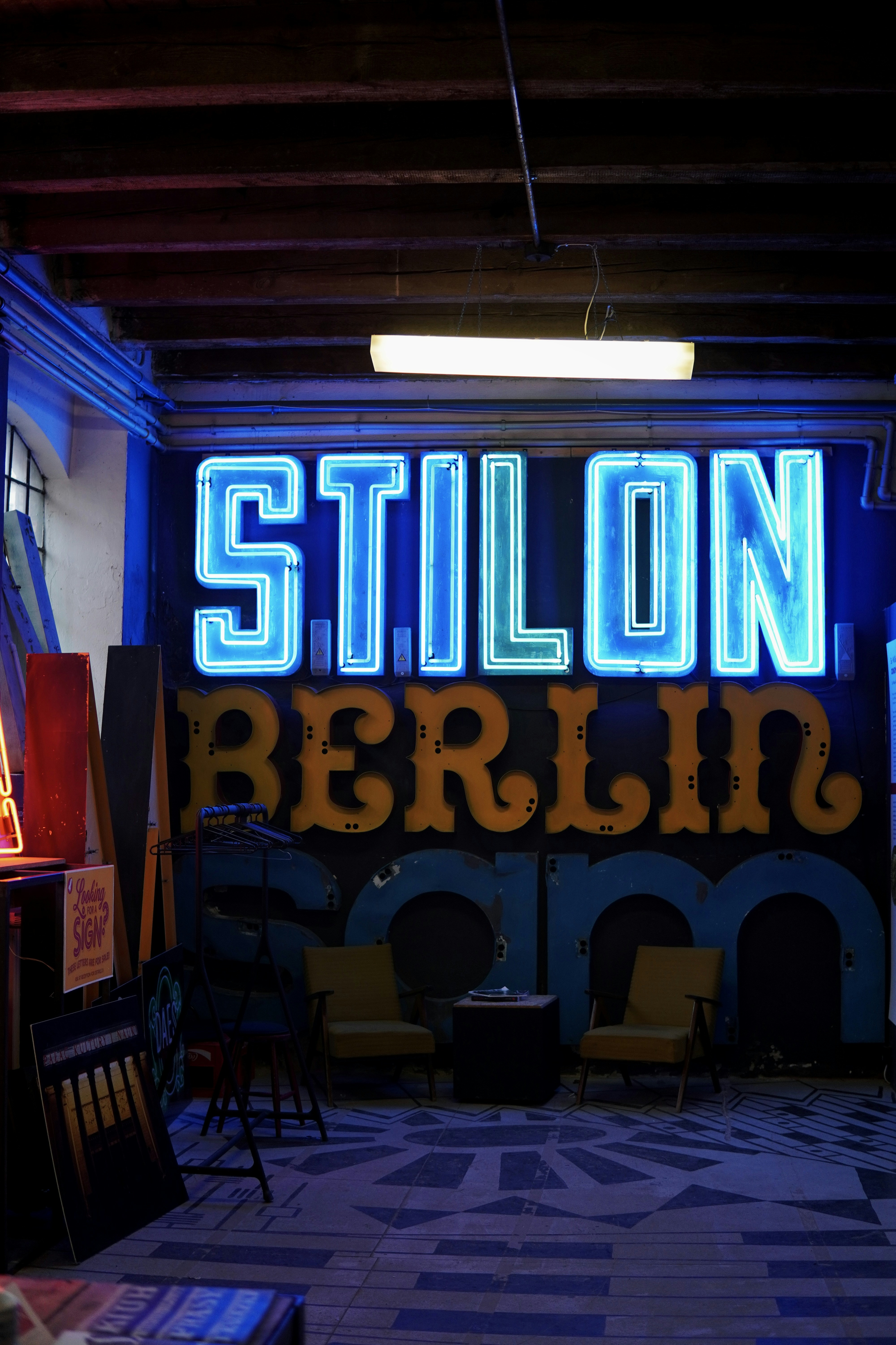 A room with a neon sign on the wall