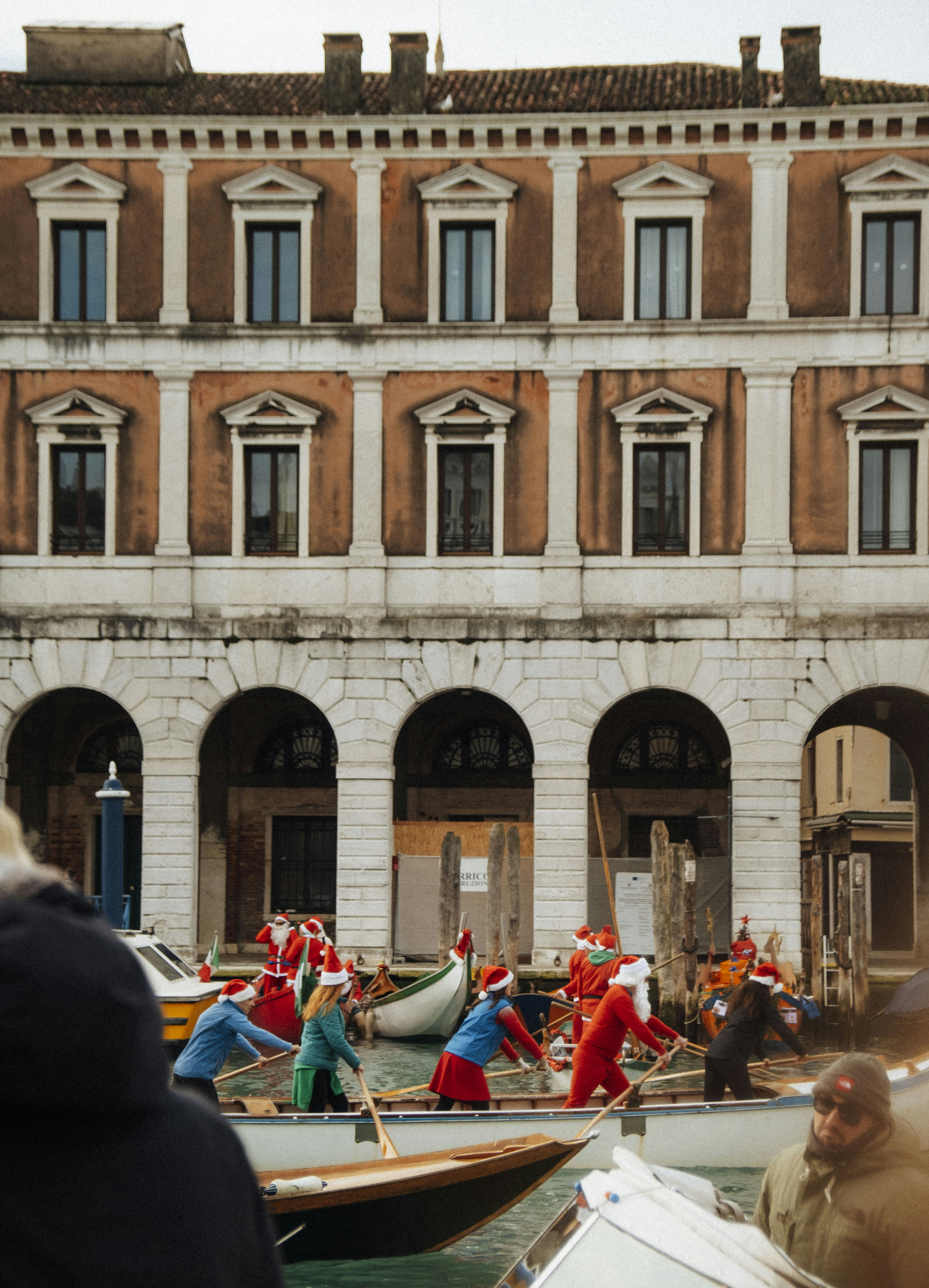 A group of people riding on top of small boats photo – Free Christmas ...