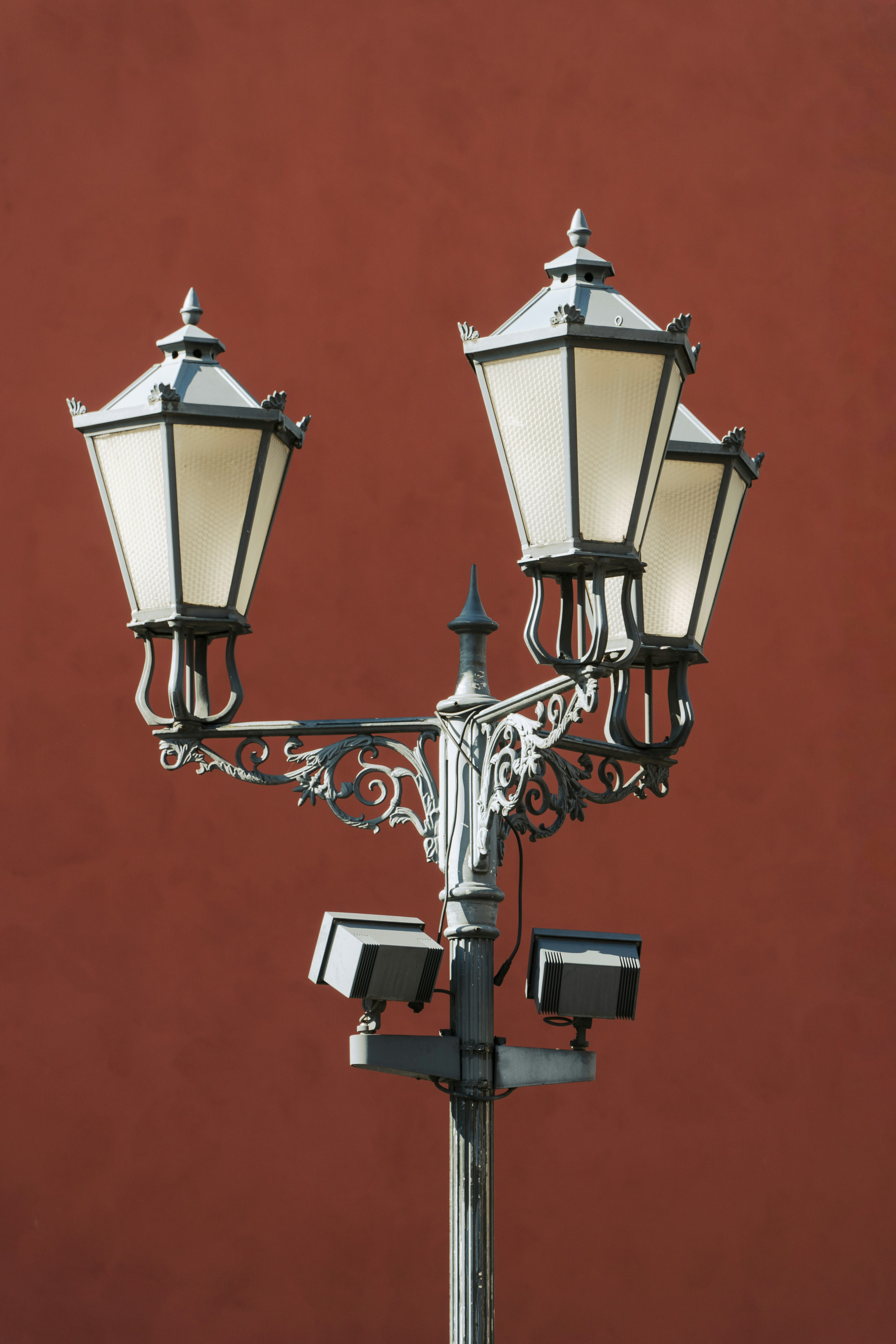 A couple of street lights sitting on top of a metal pole