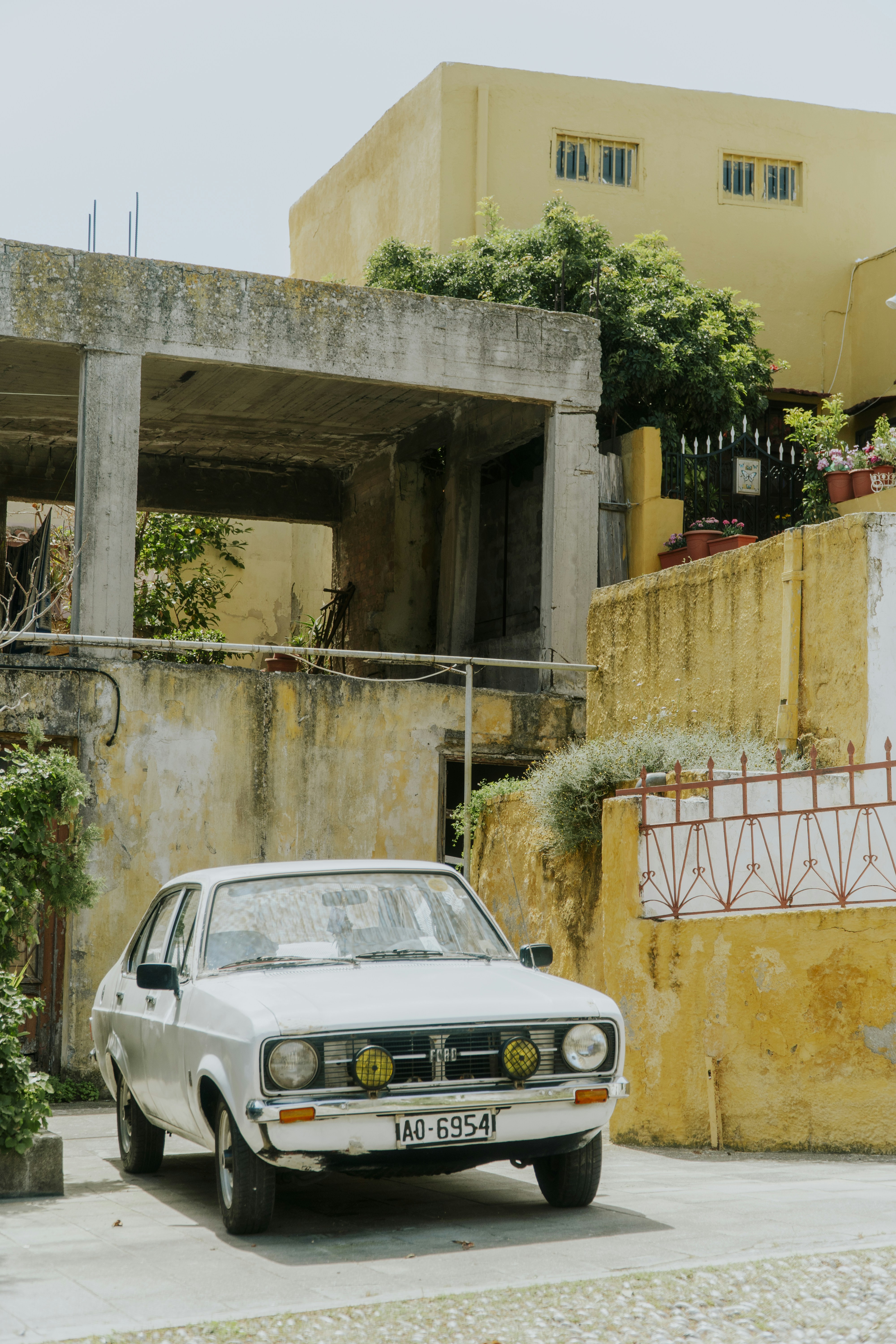 A white car parked in front of a building