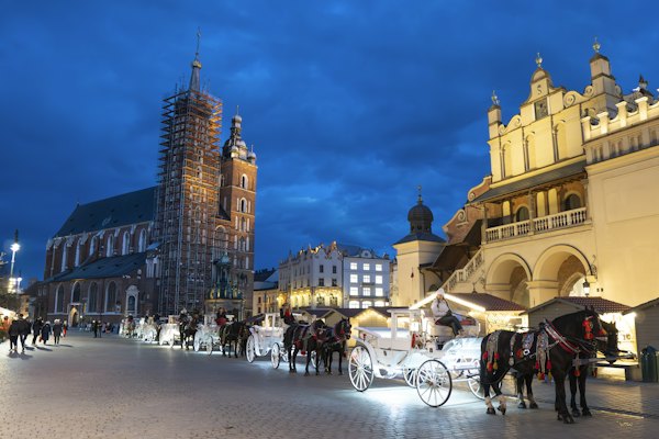 St Mary's basilica over the Main Square at dusk, where the bars are — Krakow, Poland