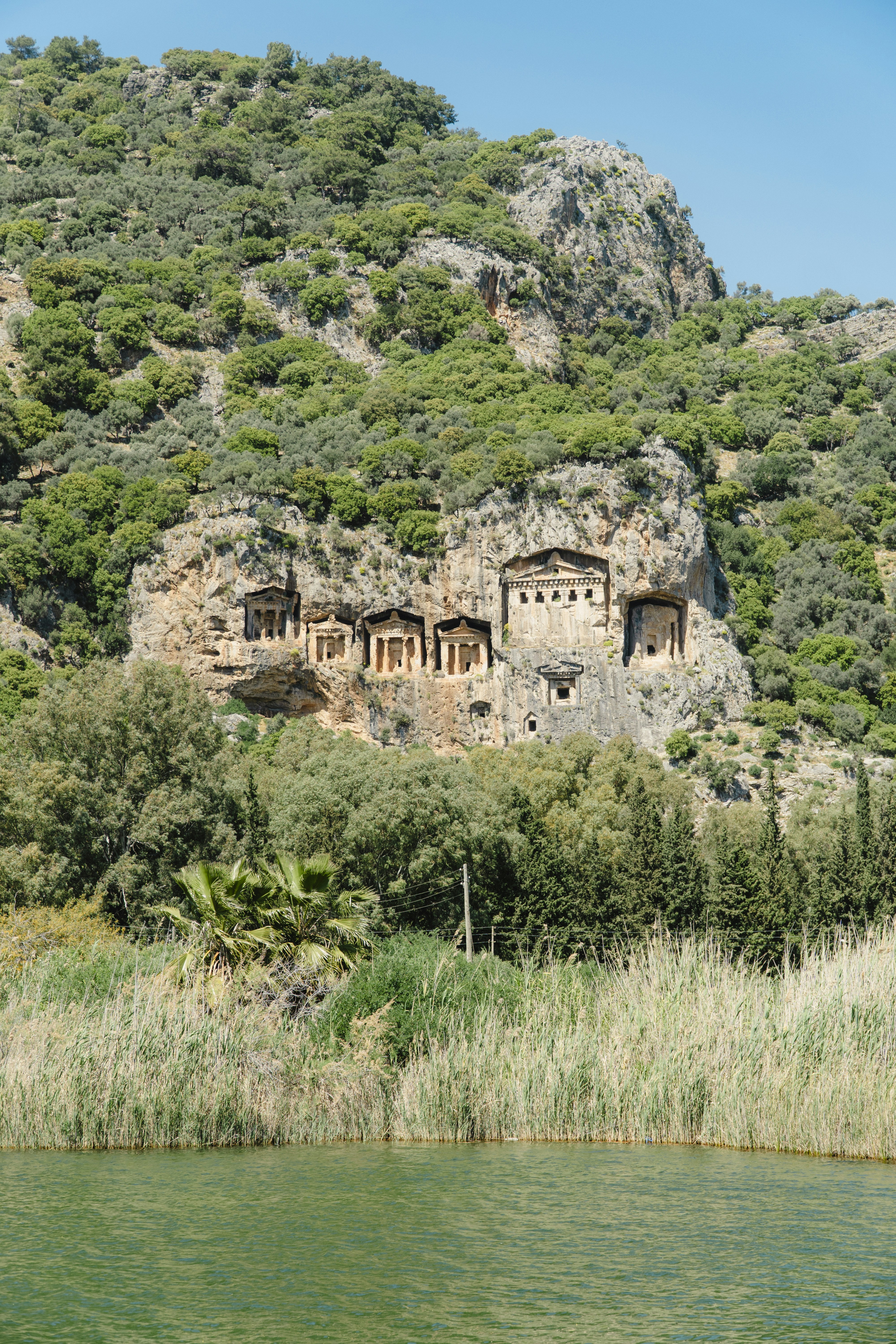 A mountain side with a body of water in front of it