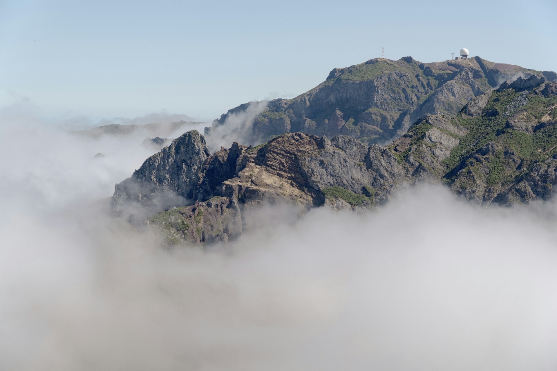 A view of a mountain in the clouds