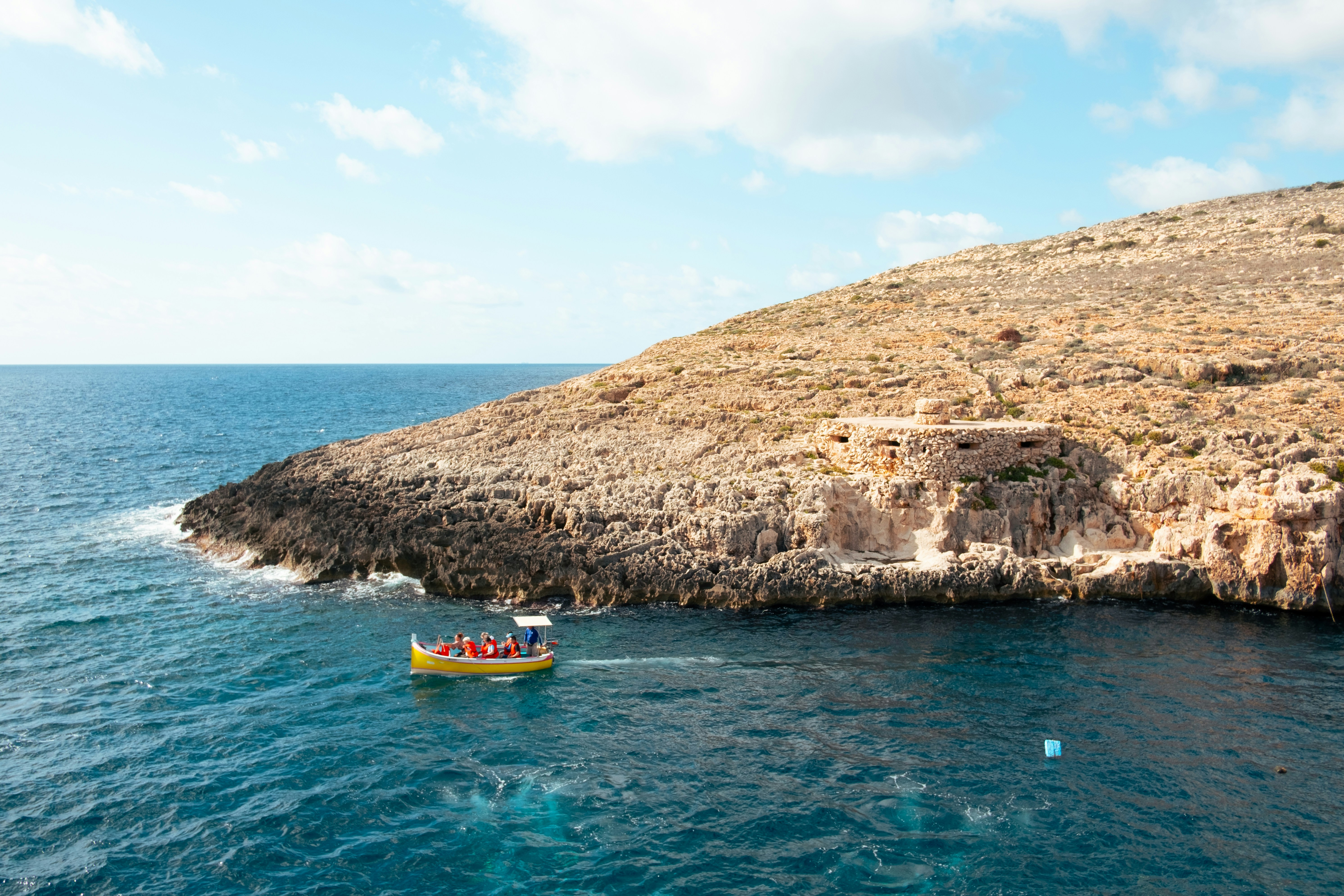 A small boat in the middle of a body of water