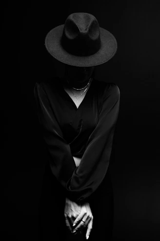A woman wearing a hat and a black dress