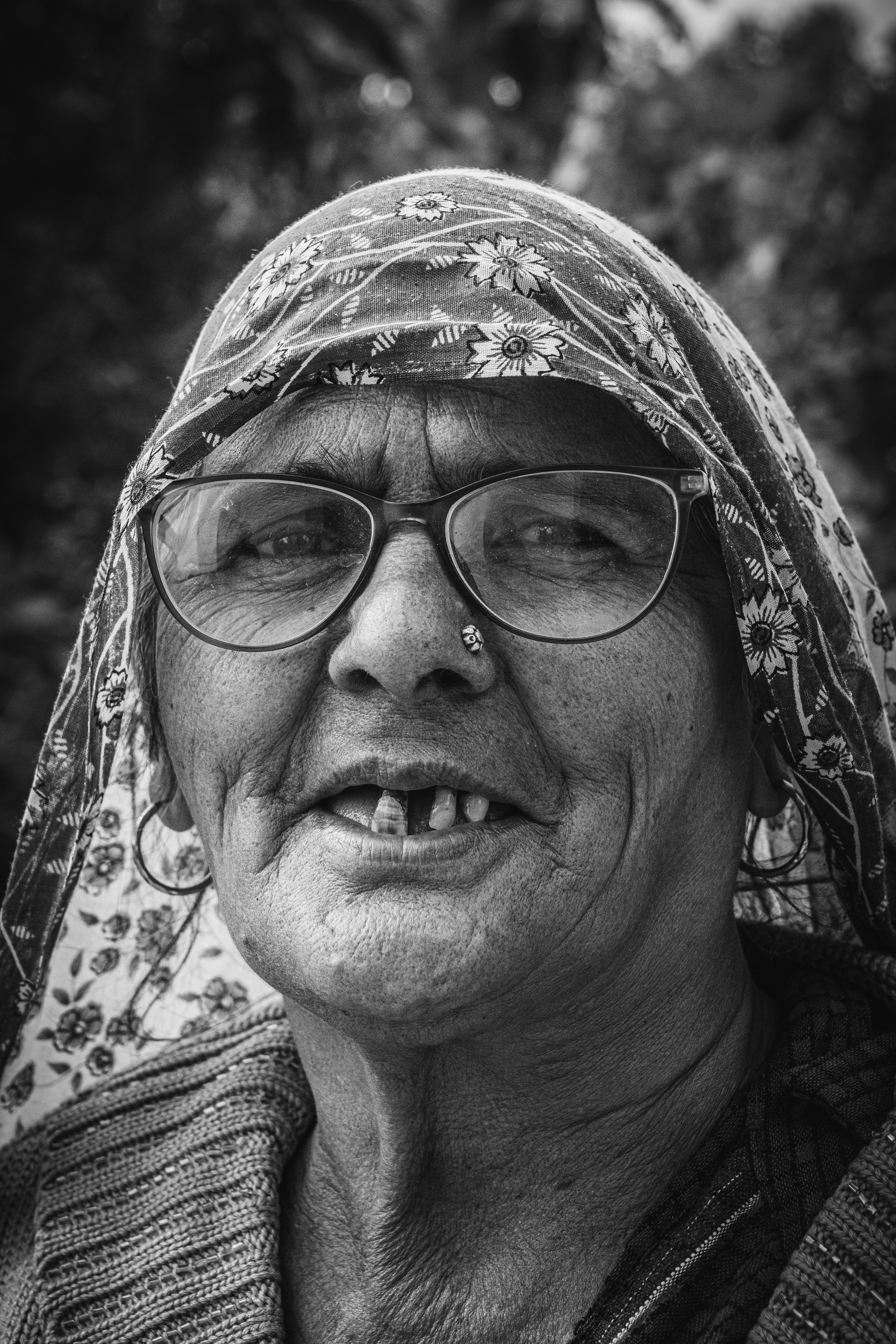 A black and white photo of a woman wearing glasses