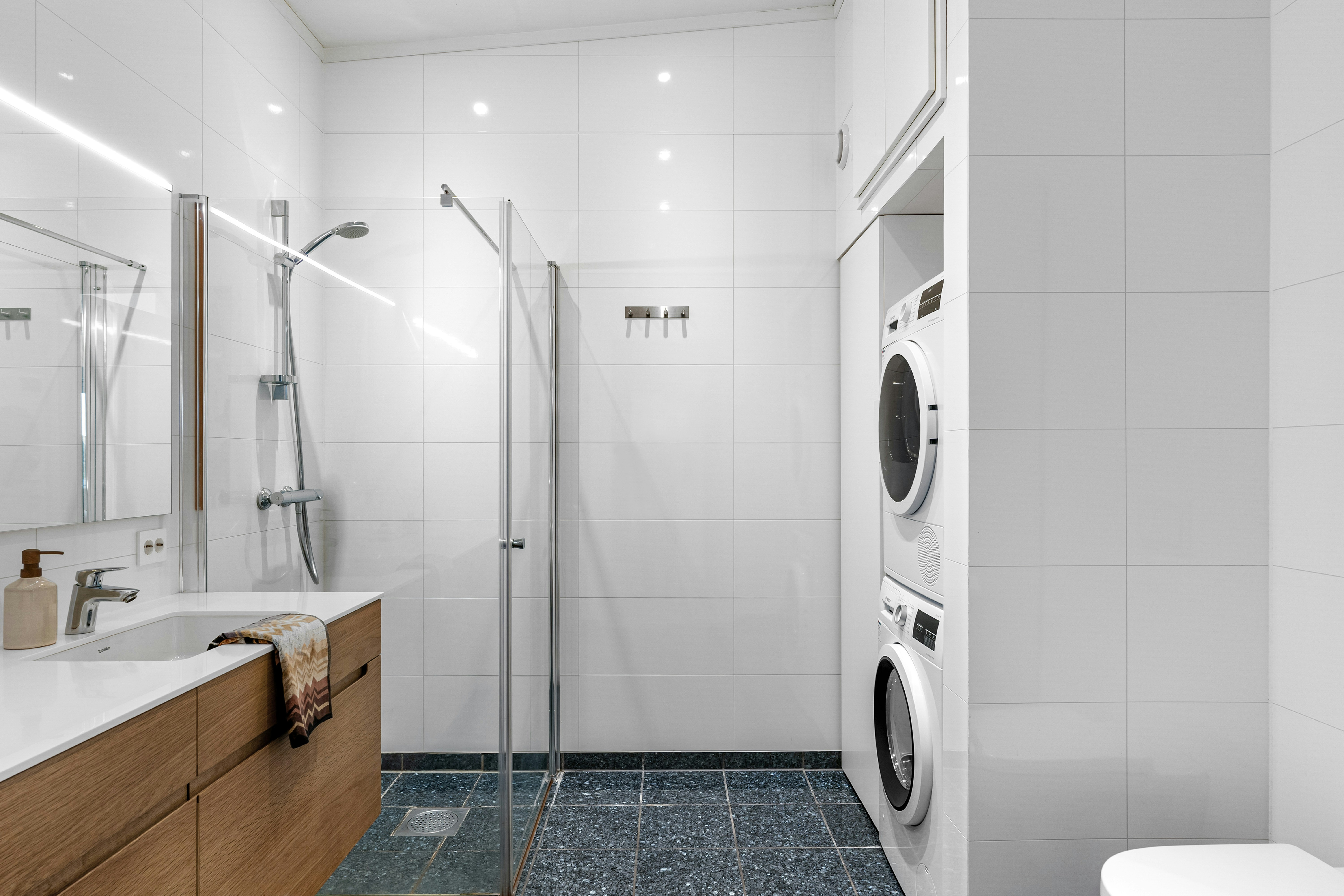 A bathroom with a washer and dryer in it