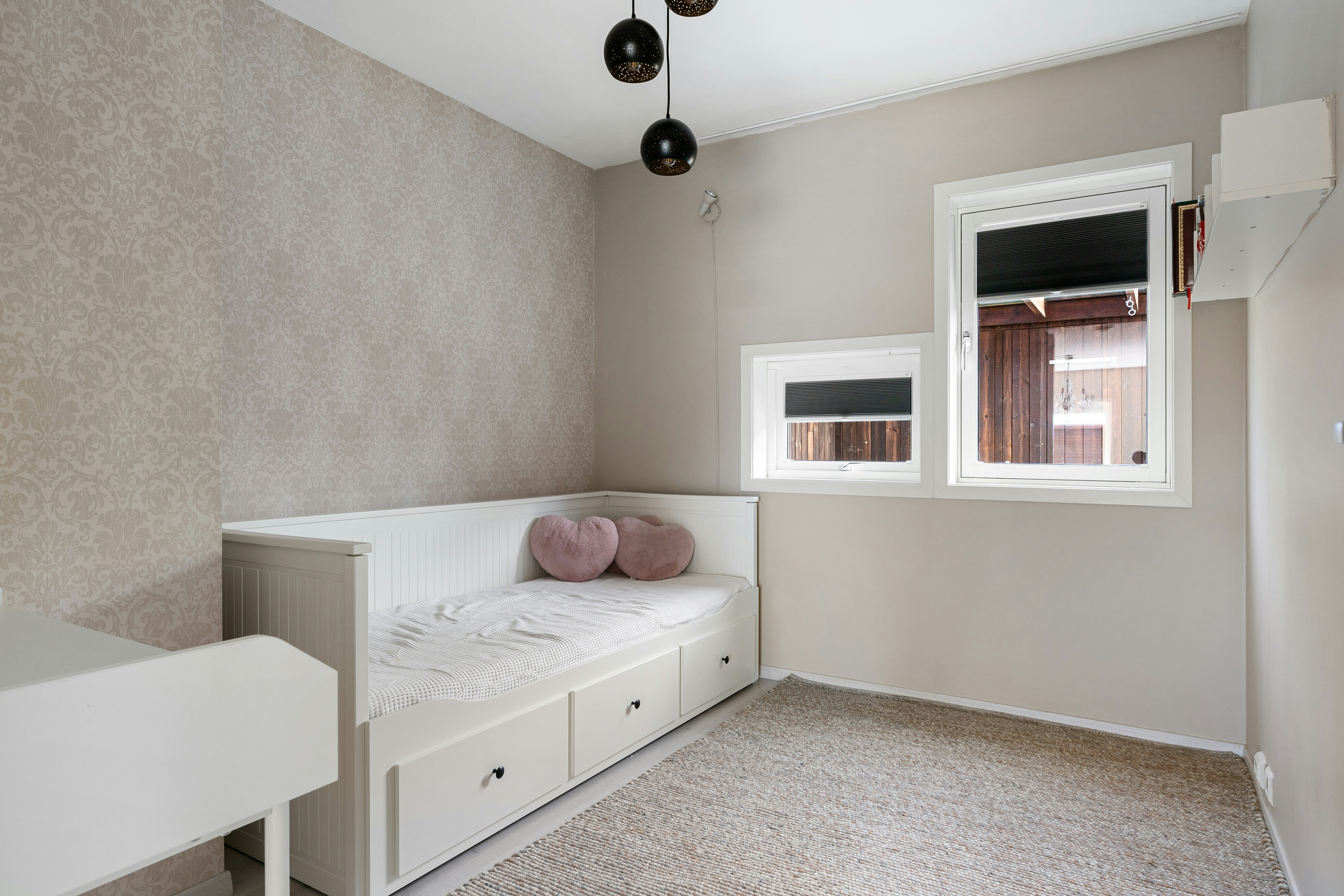 A room with a bed and a desk in it