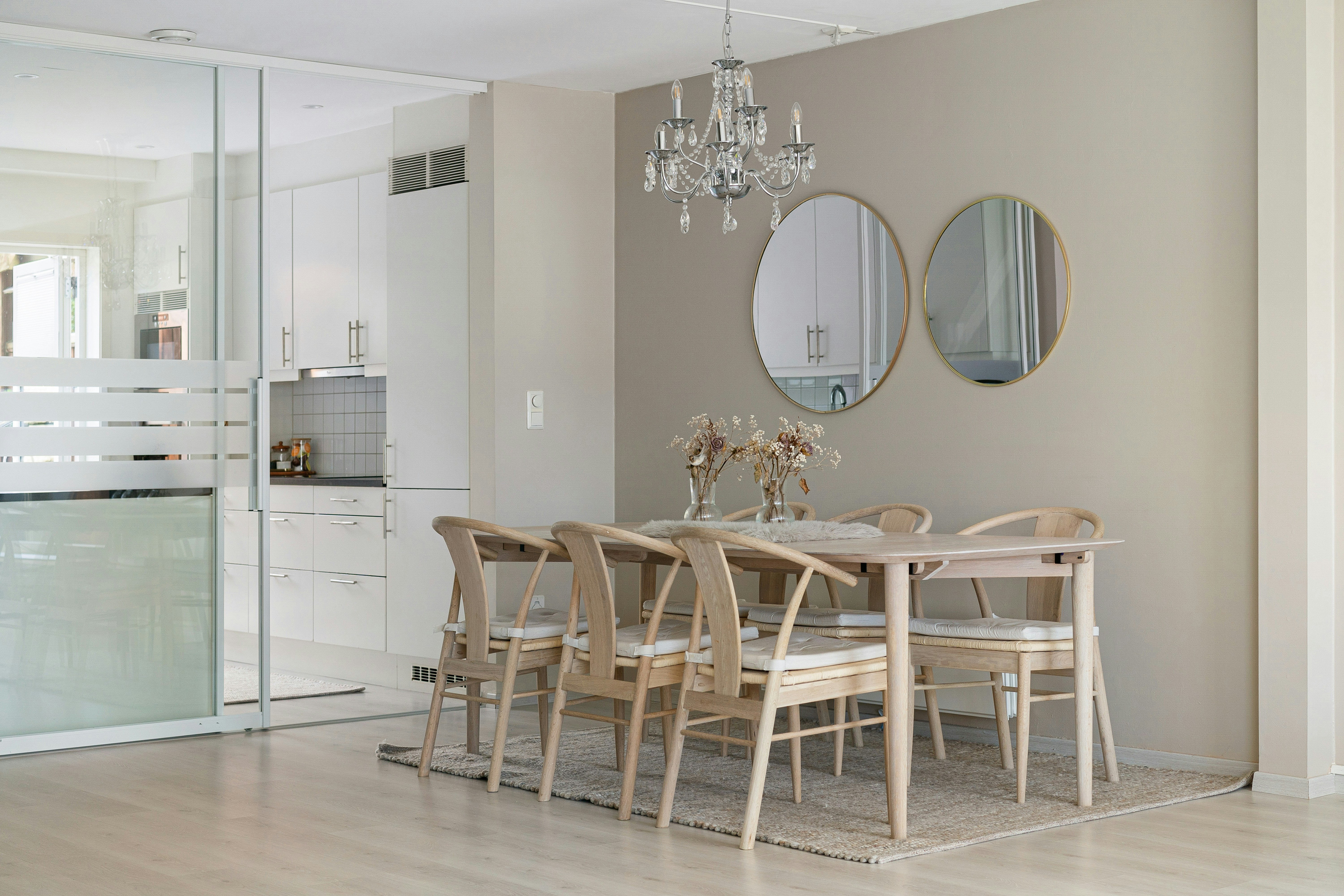 A dining room table with chairs and a chandelier