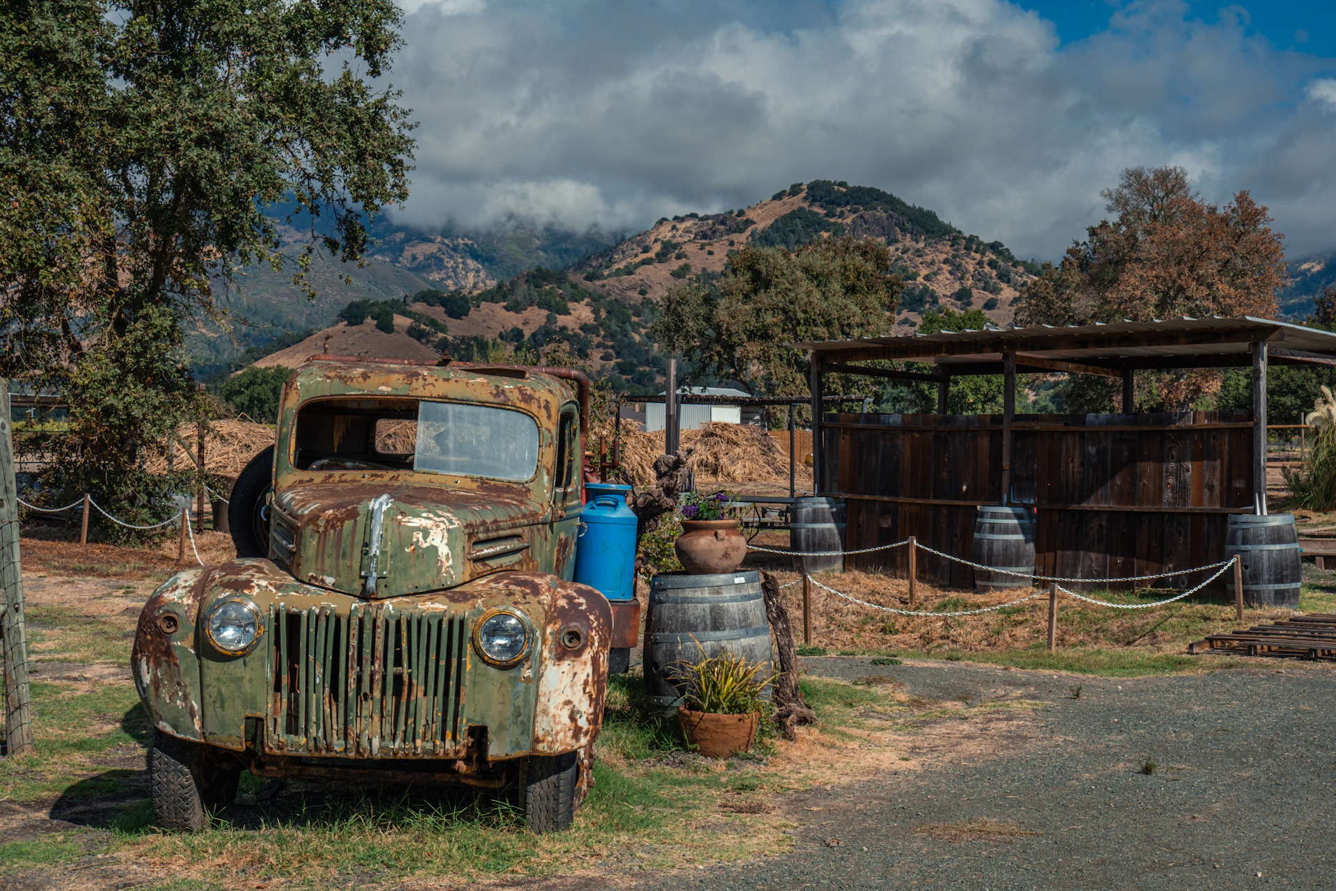 An old truck is parked in a field