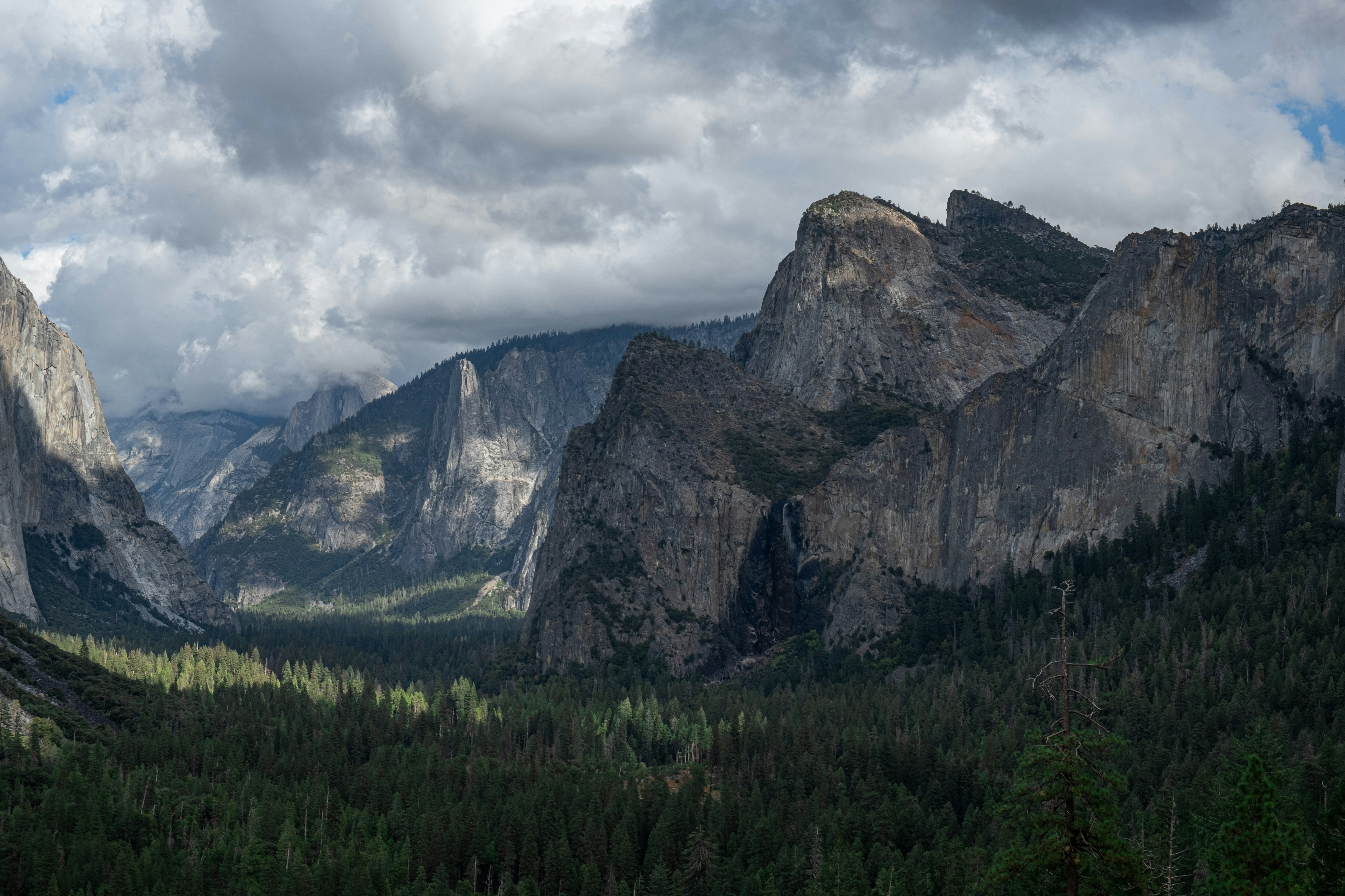 A view of a valley with mountains in the background