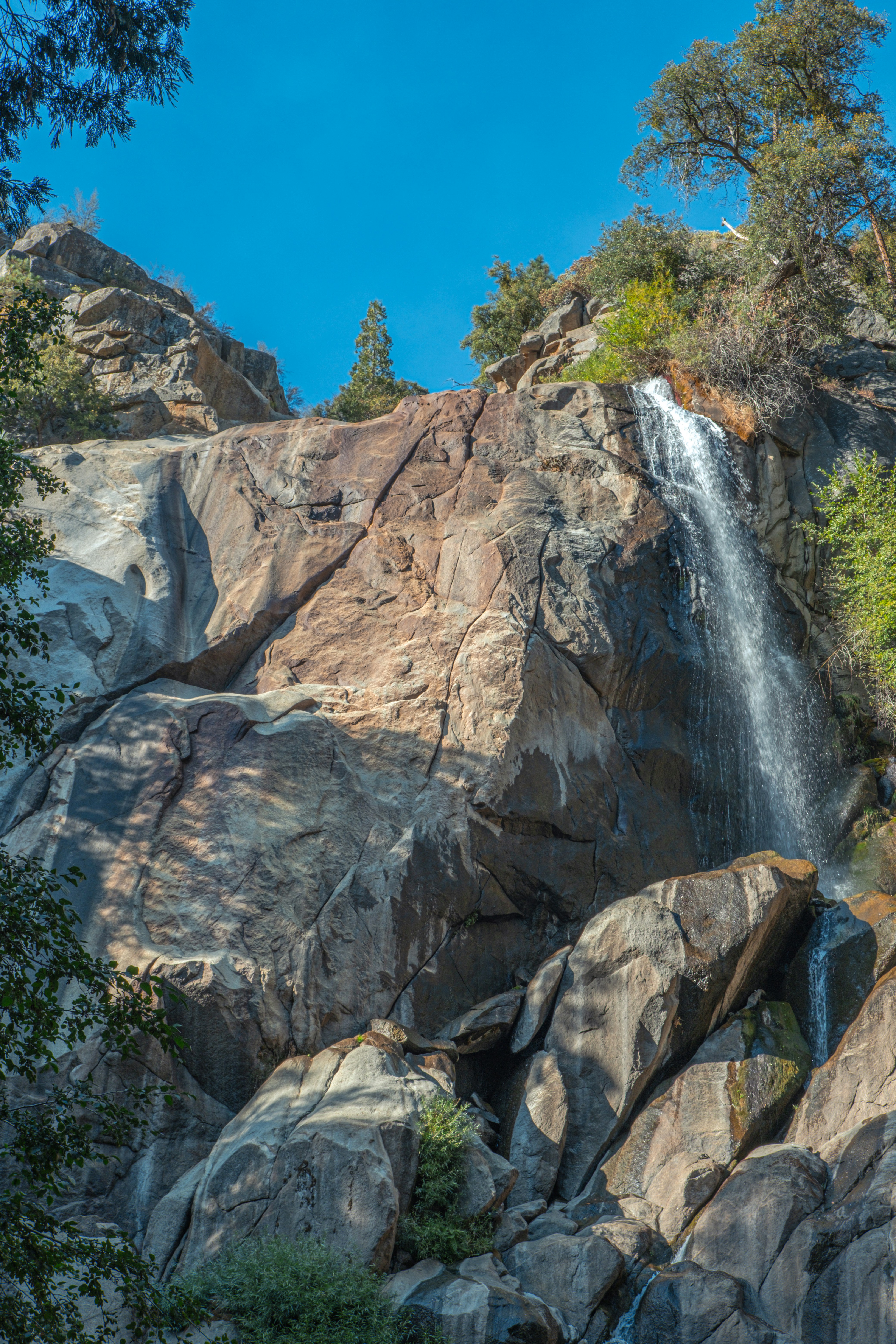 A large waterfall cascading over a rocky hillside